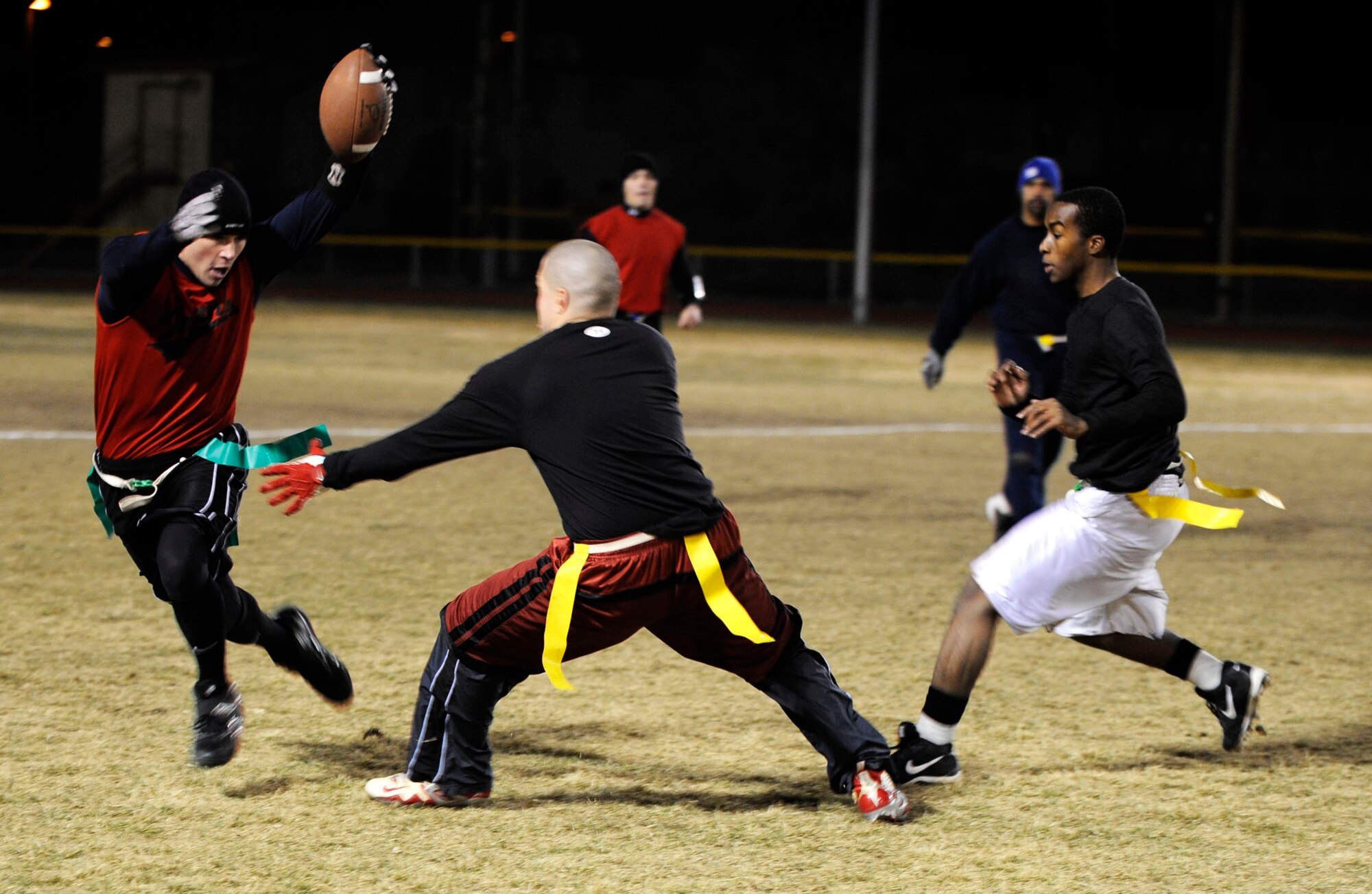 MOUNTAIN HOME AIR FORCE BASE, Idaho -- Christopher Sage, 366th Logistics Readiness Squadron quarterback, dodges members of the 366th Fighter Wing during the final game of squadron flag football Dec. 5. 366th LRS took the title with a 25-6 win. (U.S. Air Force photo/ Airman 1st Class Samantha S. Crane)