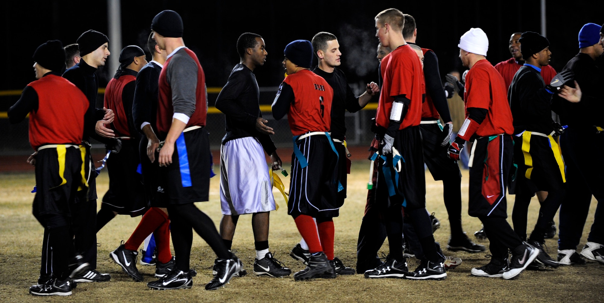 MOUNTAIN HOME AIR FORCE BASE, Idaho -- Members of the 366th Logistics Readiness Squadron and 366th Fighter Wing shake hands after facing off in the final game of squadron flag football Dec. 5. 366th LRS took the title with a 25-6 win. (U.S. Air Force photo/ Airman 1st Class Samantha S. Crane)