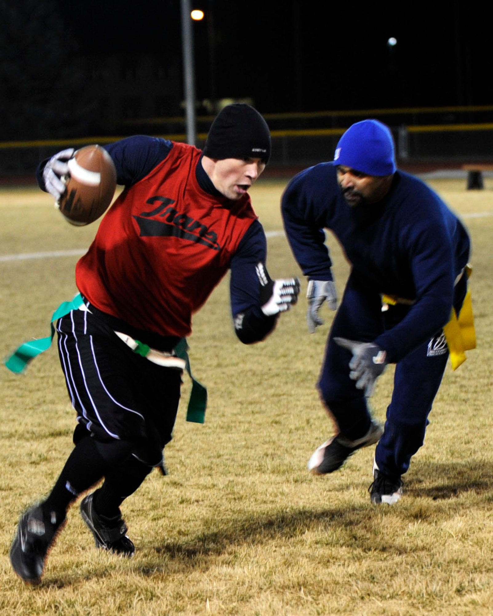 MOUNTAIN HOME AIR FORCE BASE, Idaho -- Christopher Sage, 366th Logistics Readiness Squadron wide receiver, dodges Ramon Roman, 366th Fighter Wing defensive lineman, during the final game of squadron flag football Dec. 5. 366th LRS took the title with a 25-6 win. (U.S. Air Force photo/ Airman 1st Class Samantha S. Crane)