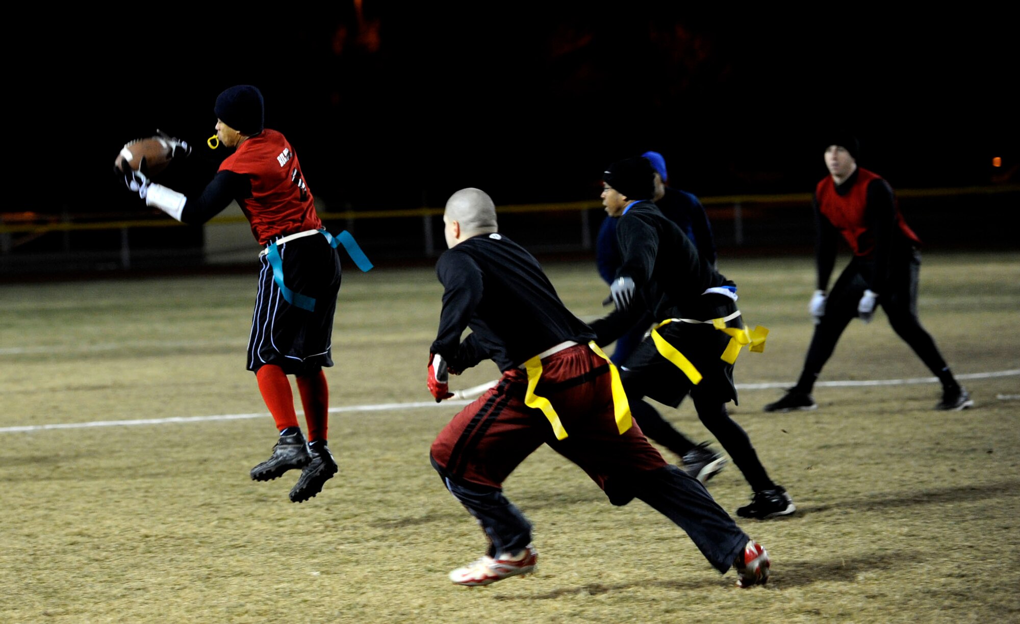 MOUNTAIN HOME AIR FORCE BASE, Idaho -- Sherard Bilbo, 366th Logistics Readiness Squadron wide receiver, catches a pass while members of the 366th Fighter Wing close in during the final game of squadron flag football Dec. 5. 366th LRS took the title with a 25-6 win. (U.S. Air Force photo/ Airman 1st Class Samantha S. Crane)