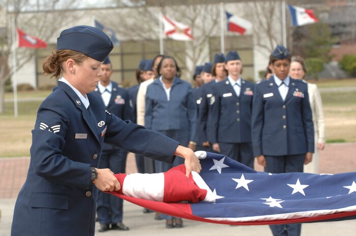 In June, Gen. Arthur Lichte, Air Mobility Command commander, issued a call for all mobility Airmen to return to basics and he thanks them for their renewed attention to the core values and mobility mission. Senior Airman Meredith Greer folds the American flag during the retreat ceremony March 14 on Charleston AFB. Airmen Greer is with the 437th Civil Engineer Squadron. (U.S. Air Force photo/James Bowman)