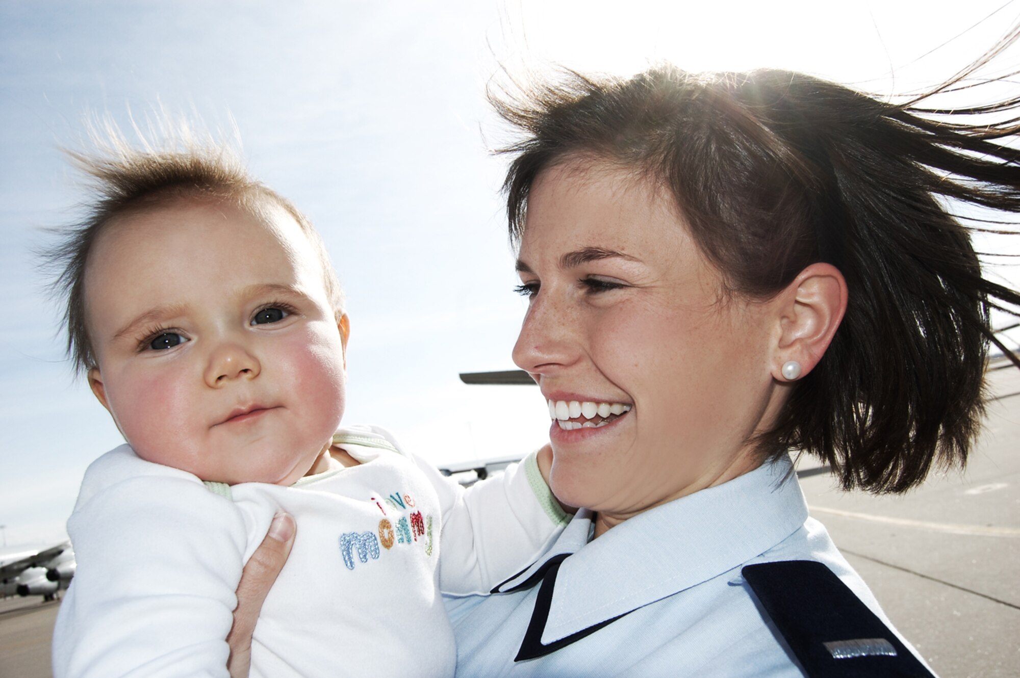 First Lieutenant Kinder Blacke, 552nd Air Control Wing, and her son, Reginald "Reggie" Blacke smile for the camera while taking pictures for the Double Duty project. Photo compliments of Ms. AnnaMarie Garcia.