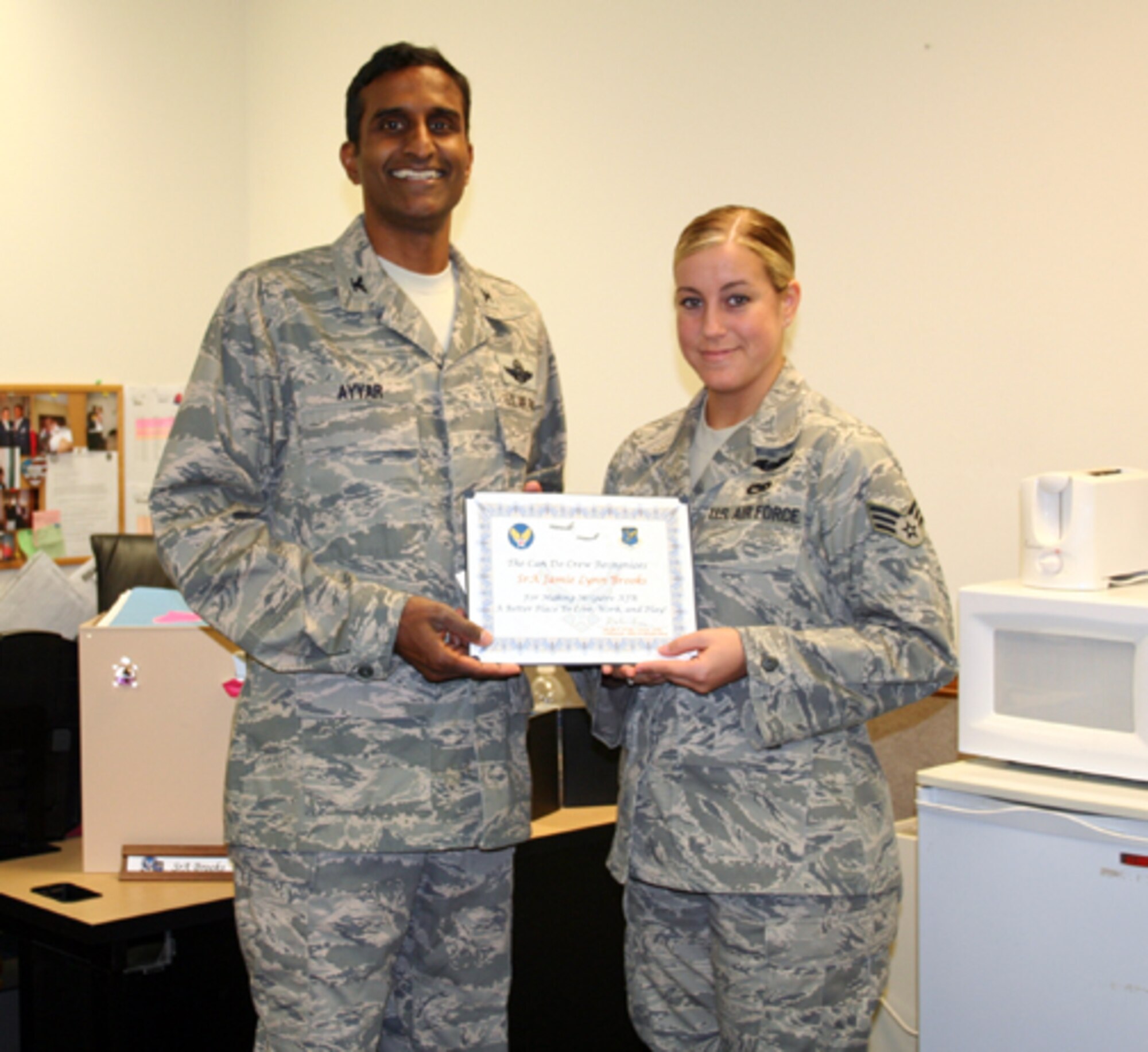 Right, Col. Balan Ayyar, 305th Air Mobility Wing commander, presents a McGuire Can Do Crew award to Senior Airman Jamie Lynn Brooks, 305th Maintenance Operations Squadron. Her nomination is as follows: “Although Airman Brooks has only been in the analysis career field for a little more than two years, her quick thinking and outstanding professionalism will lead you to think she is a veteran of the field. Due to low-manning issues, she has single-handedly managed both of her section's analyst programs for KC-10s and C-17s for more than six consecutive months. The reports are always on time, and her proactive approach ensures the job gets done well. As the office training monitor, she ensures her nine co-workers comply with all training requirements on a weekly basis. Additionally, her section can always count on her to remember everyone’s birthday’s and coordinate the celebrations. She comes in every day with a positive attitude ready to perform her best. Her co-worker, Staff Sgt. Erin Smith said, ‘Airman Brooks brings laughter, knowledge, enthusiasm and a Can Do attitude to everything she does ... It is people like (Airman Brooks) that make working in the 305th MOS a joyful and proud experience.’"

Be aware that the Can Do Crew is everywhere, looking for outstanding service.  They covertly seek members of Team McGuire who make a difference, identifying and recognizing only the best! Remember, the strongest asset of Team McGuire is its people; you are what makes McGuire a better place to live, work and play!