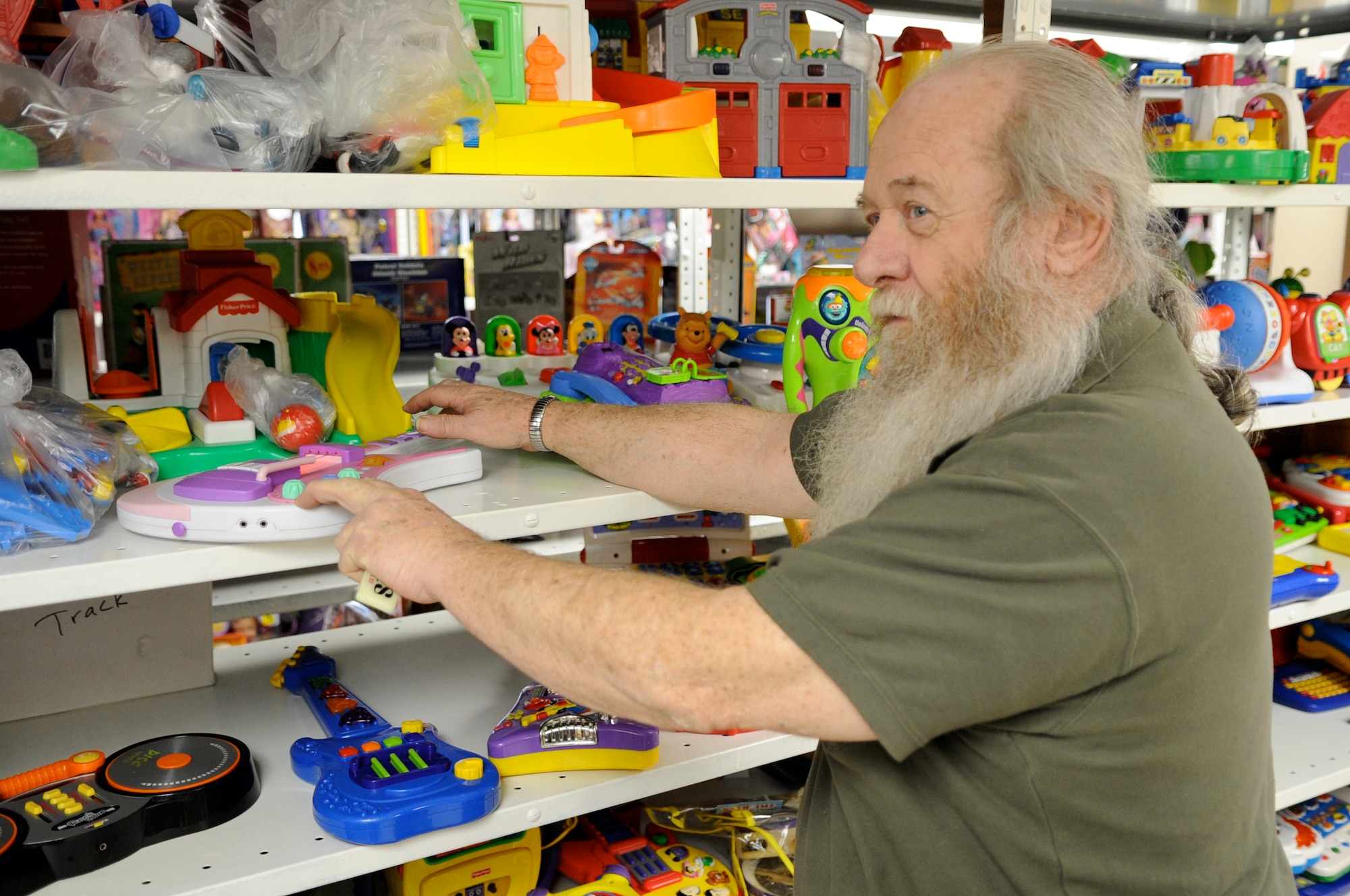 Vince Bowker, Operation Santa president, tests a donated toy at the workshop. All donated toys are inventoried, cleaned and tested before being placed on shelves for customers. Operation Santa accepts toy donations for local families in need during the holidays. Toys are collected year-round at Fort Dix Bldg. 5343. (U.S. Air Force photo/Charles Russell)
