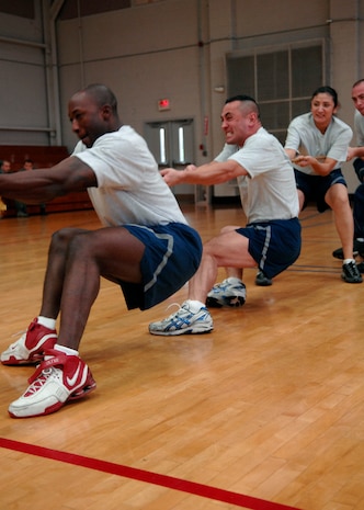 Airmen of the 437th Communications Squadron pull the rope during the tug-of-war match at the Fitness and Sports Center on Charleston AFB Dec. 5. More than 100 Charleston Airmen participated in the Commander's Fitness Challenge. The 437th Logistics Readiness Squadron won the overall competition. (U.S. Air Force photo/Airman 1st Class Katie Gieratz)
