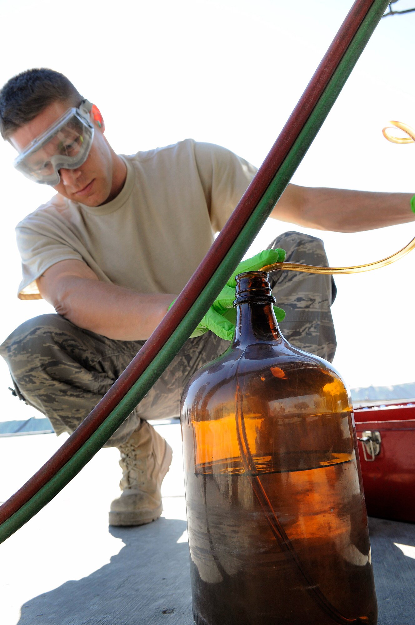 Staff Sgt. Ronald Gasper fills a bottle with JP-8 fuel to perform a bottle method test Dec. 8 at an air base in Southwest Asia. The bottle method test is used to test a fuel truck's filter separator and measures the amount of impurities in the fuel. Sergeant Gasper is a fuels lab technician assigned to the 379th Expeditionary Logistics Readiness Squadron and deployed from Scott Air Force Base, Ill. He is a native of Omaha, Neb. (U.S. Air Force photo/Tech. Sgt. Michael Boquette) 
