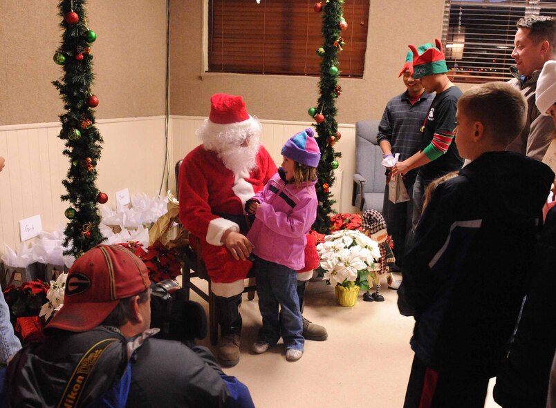DYESS AIR FORCE BASE, Texas —Children gathered around to partake of cookies and visit with Santa Clause after a Menorah and Christmas Tree Lighting ceremony held at the base chapel Dec. 3. This is an annual event the chapel hosts,  open to all military and their families to celebrate the December holidays. (U.S. Air Force photo/Senior Airman Domonique Simmons)