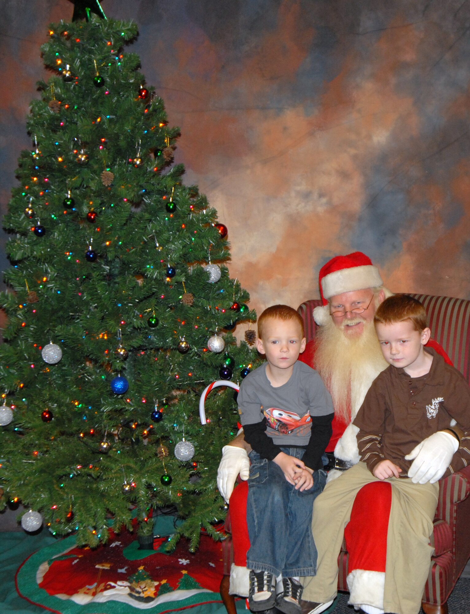 Scott and Joshua Chadwick, sons of Staff Sgt. Scott Chadwick, 436th Logistics Readiness Squadron, sit on Santa’s lap at The Landings Club, Dec. 7. Sergeant Chadwick is currently deployed to Tallil Air Base, Iraq, and his wife, Disa, and sons wished for his safety this Christmas. (U.S. Air Force photo by Tech. Sgt. Kevin Wallace)