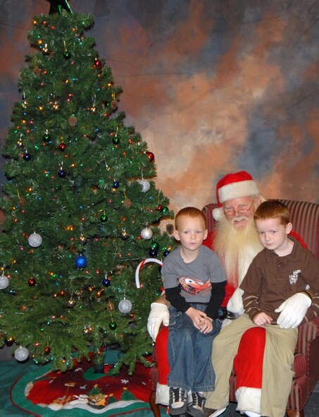 Scott and Joshua Chadwick, sons of Staff Sgt. Scott Chadwick, 436th Logistics Readiness Squadron, sit on Santa’s lap at The Landings Club, Dec. 7. Sergeant Chadwick is currently deployed to Tallil Air Base, Iraq, and his wife, Disa, and sons wished for his safety this Christmas. (U.S. Air Force photo by Tech. Sgt. Kevin Wallace)
