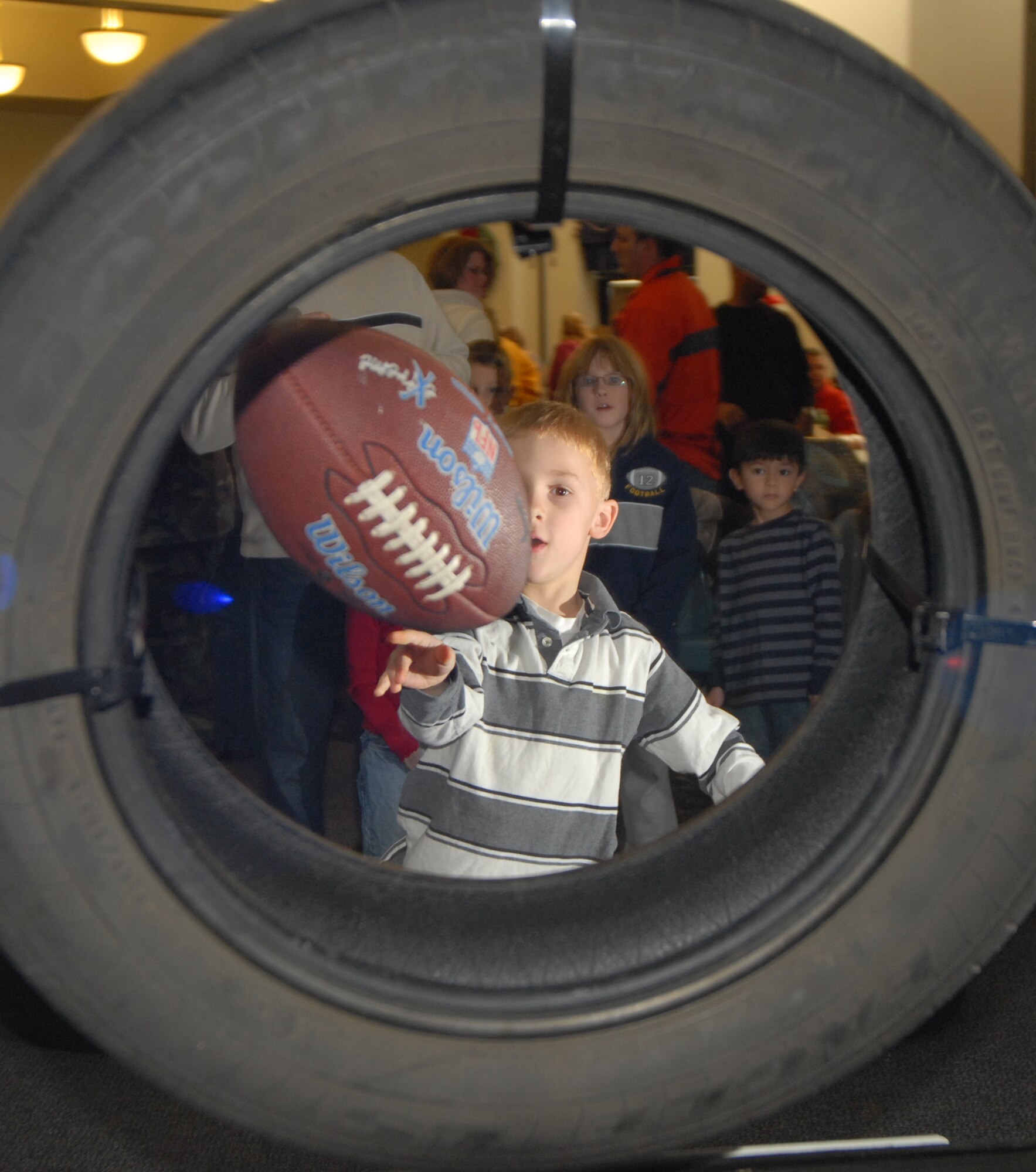 Gregory Mason, son of Tech. Sgt. Harold Mason, 9th Airlift Squadron, scores a win in the football toss at the 2008 Wing Children’s Christmas Party at The Landings Club, Dec. 7. The Dover First Sergeant’s Council sponsored the event, which was free to all assigned Airmen and their families. (U.S. Air Force photo by Tech. Sgt. Kevin Wallace)