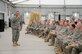 SOUTHWEST ASIA -- The 380th Air Expeditionary Wing Command Chief, Chief Master Sgt. Kent Smith, addresses a crowd of over 400 Airmen during the warfighter briefing here Dec. 10. The chief directed his comments toward the health and well-being of the Airmen as they near the close of their deployment. The briefing is intended to share highlights from the AEF rotation and remind Airmen to stay focused through the transition.  (US Air Force photo by Tech. Sgt. Christopher Campbell) (released) 