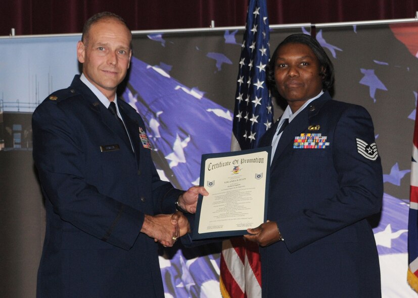 Staff Sgt. Yolanda D. Julin is promoted to the rank of technical sergeant by Maj. Kenneth Dewlen, the 100th Force Support Squadron commander, during the promotion ceremony held at the base theater Aug. 29, 2008, in RAF Mildenhall, England. (U.S. Air Force photo by Staff Sgt. Jerry Fleshman)