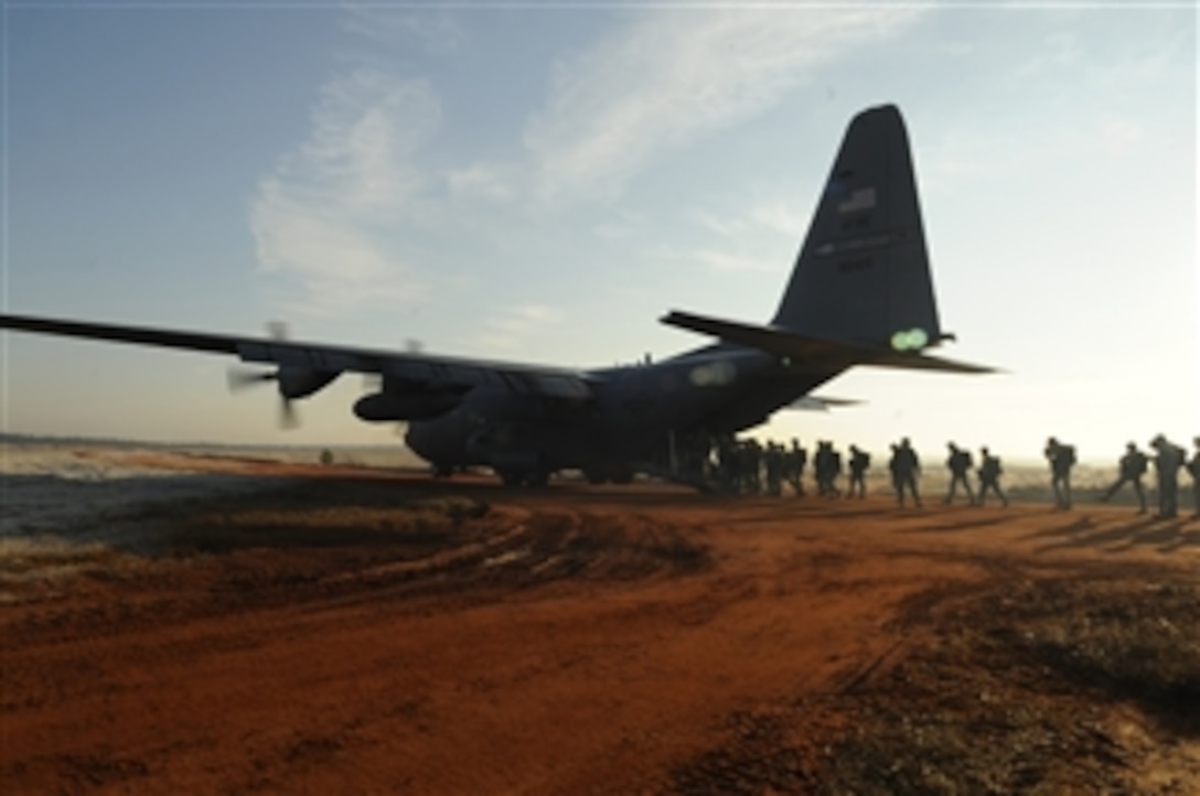 A U.S. Air Force C-130 Hercules from the 2nd Airlift Squadron, 440th Airlift Wing out of Pope Air Force Base, N.C., parks at a drop zone at Fort Bragg, N.C., on Dec. 6, 2008.  Soldiers from the 82nd Airborne Division are being picked up so they can jump to earn foreign jump wings during Operation Toy Drop.  Operation Toy Drop is an annual jump hosted by the U.S. Army Civil Affairs and Psychological Operations Command (Airborne), and supported by Fort Bragg's XVIII Airborne Corps and Pope Air Force Baseís 43rd Airlift Wing.  In its 11th year, Operation Toy Drop gives soldiers and airmen the opportunity to help local families in need while boosting morale and incorporating valuable training.  
