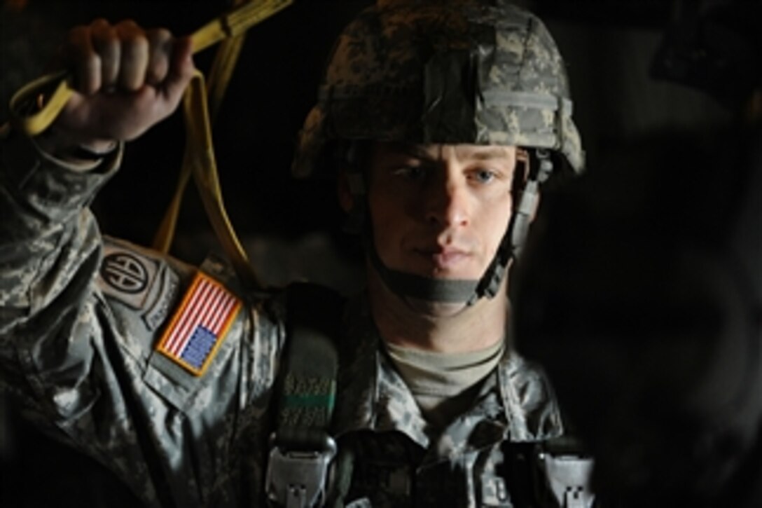 A U.S. Army soldier from the 82nd Airborne Division, Fort Bragg, N.C., prepares to parachute from a C-130 Hercules aircraft during Operation Toy Drop at Fort Bragg, N.C., on Dec. 6, 2008.  Operation Toy Drop is an annual airborne jump hosted by the U.S. Army Civil Affairs and Psychological Operations Command (Airborne) and supported by Fort Braggís XVIII Airborne Corps and Pope Air Force Base's 43rd Airlift Wing.  In support of the exercise, soldiers donate a toy for a lottery ticket giving them the chance to jump under a foreign jumpmaster to earn their foreign jump wings.  