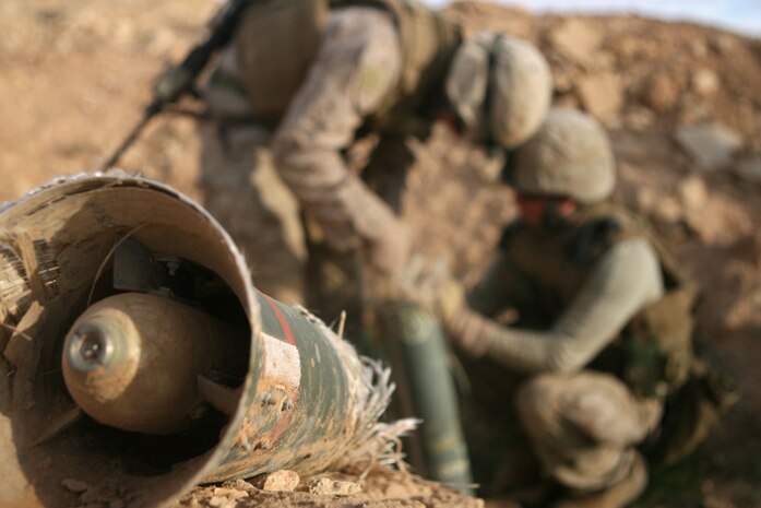Lance Cpl. Joshua D. Anders (back) and Cpl. Andrew R. Semp (front), both engineers with 1st Combat Engineer Battalion, Task Force Mech, Regimental Combat Team 5, inspect a piece of ordnance which was found in al-Anbar province, Iraq, Dec. 10.  Task Force Mech consists of Marines and sailors with Company A, 2nd Tank Battalion, in conjunction with elements of Company B, 1st Light Armored Reconnaissance Bn., and 1st Combat Engineer Bn.  The Marines and sailors with Task Force Mech are conducting various missions in al-Anbar province to include presence patrols and humanitarian missions.