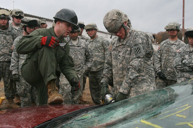 Marine Sgt. Mark Warner (left), technical rescue technician, Chemical Biological Incident Response Force, II Marine Expeditionary Force, shows an Army soldier, SPC. Dale Sloniger (right) from 1st Heavy Brigade Combat Team, 3rd Infantry Division, how to safely cut through a windshield. BCT 1-3 is the first active-duty Army unit tasked with the mission of chemical, biological, radiological, nuclear, and high-yield explosive consequence management.