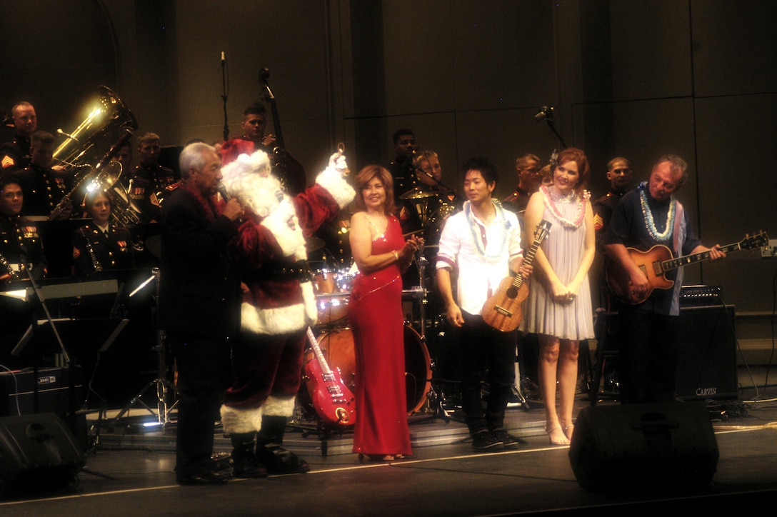 (From left to right) Danny Kaleikini, Santa Claus, Carole Kai, Jake Shimabukuro, Anita Hall and Chris Vandercook say a few last words of gratitude to an audience of around 1,500 people during Na Mele o na Keiki, 'Music for the Children,' Dec. 10 at the Neal S. Blaisdell Concert Hall. All of the entertainers, including American Idol star Jasmine Trias, donated their time perfoming for the Marine Corps Reserve's annual Toys for Tots campaign.