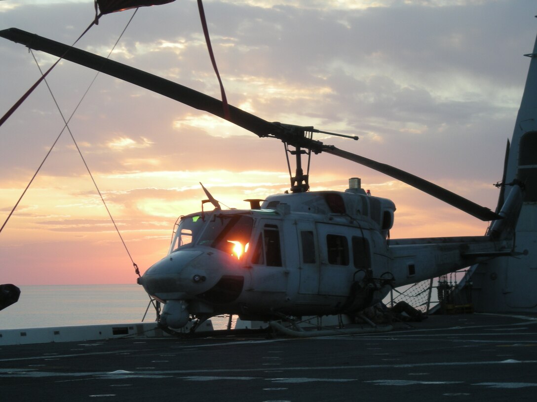 The sun sets on another day of training behind a UH-1N Huey helicopter on the flight deck of USS San Antonio, Nov. 9, 2008. Approximately 75 Marines with HMM-264, the Aviation Combat Element of the 26th Marine Expeditionary Unit, flew to the San Antonio to practice flying "skids," or non-wheeled aircraft like the Huey and AH-1W Super Cobra from the new ship.