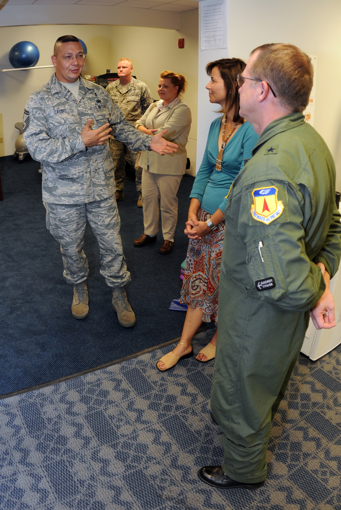 ANDERSEN AIR FORCE BASE, Guam - Brig. Gen. Phil Ruhlman, 36th Wing commander, and his wife Lina, listen as Senior Master Sgt. Leonardo Castro, 36th Medical Operations Squadron physical therapy technician, describes benefits of a physical therapy clinic on Andersen.  General Ruhlman and his wife were guests at the Dec. 11 ribbon-cutting ceremony, which marked the official opening of the new facility.  (U.S. Air Force photo by Senior Airman Jonathan Hart)