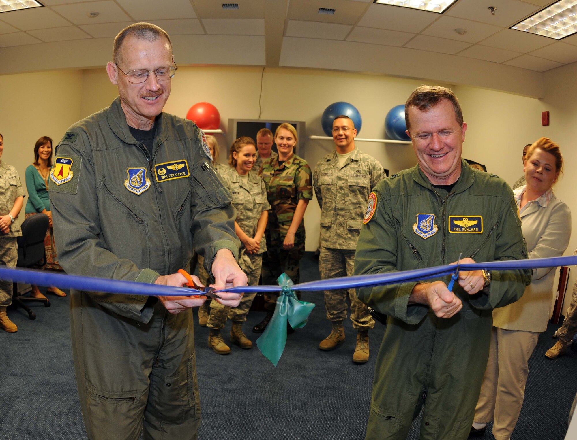 ANDERSEN AIR FORCE BASE, Guam - Col. Walter Cayce (left), 36th Medical Group commander, helps Brig. Gen. Phil Ruhlman (right), 36th Wing commander, mark the opening of Andersen's new physical therapy clinic at a ribbon-cutting ceremony Dec. 11.  The ceremony was held at the Health and Wellness Center, which houses the new facility.  (U.S. Air Force photo by Senior Airman Jonathan Hart)