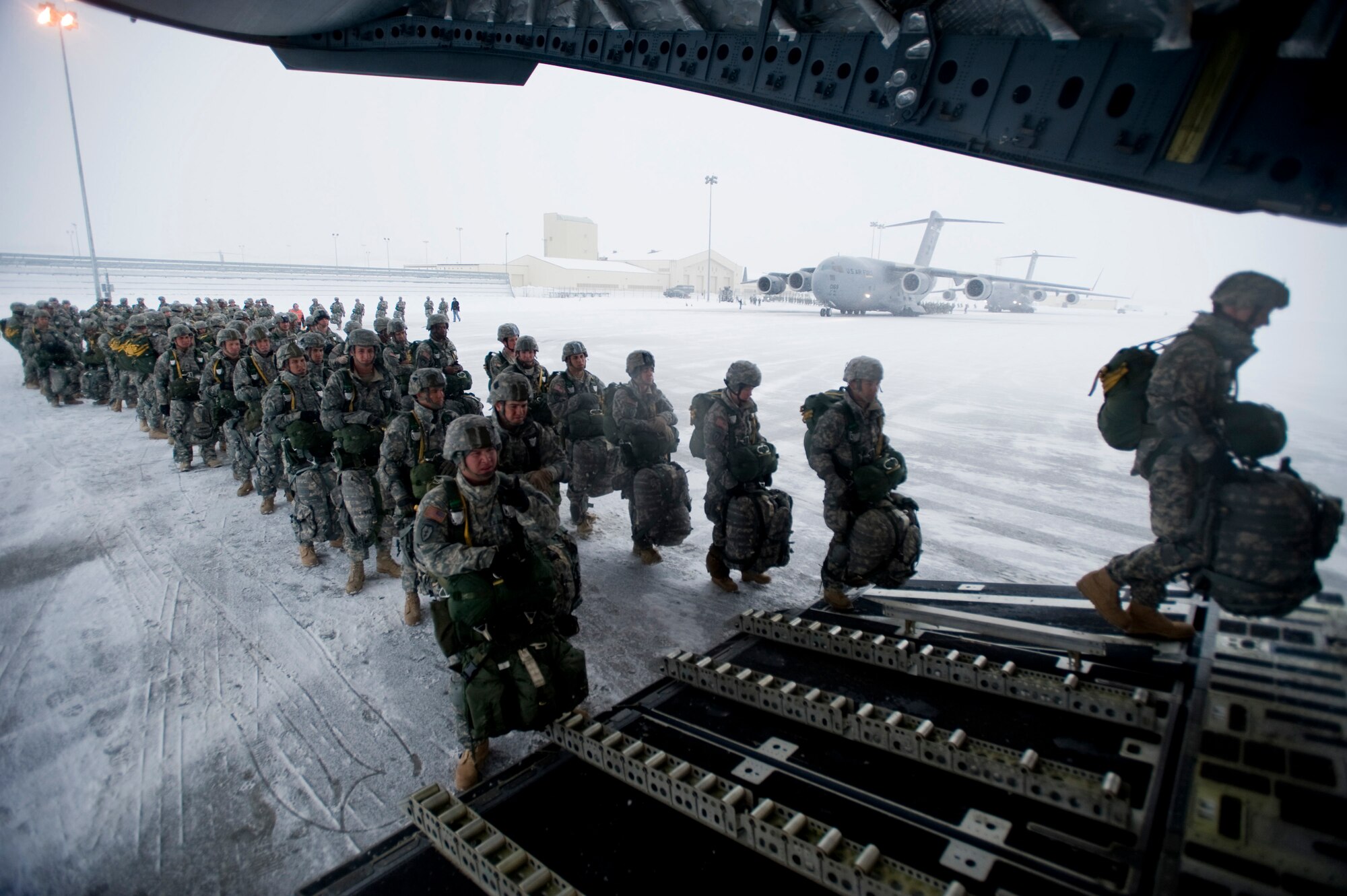 ELMENDORF AIR FORCE BASE, Alaska -- Members of the 1-501 Infantry climbs into back C-17 ramp for entry Dec. 10. The 4th Brigade Combat Team, 25th Infantry Division partnered with the 517th Airlift Squadron, Hickam and McCord Air Force Base is using this week practice jumps prior to the deployment. Roughly 1,300, 4-25 Soldiers will be jumping out of C-17 Globemaster IIIs during the week. (U.S. Air Force photo/Senior Airman Jonathan Steffen)