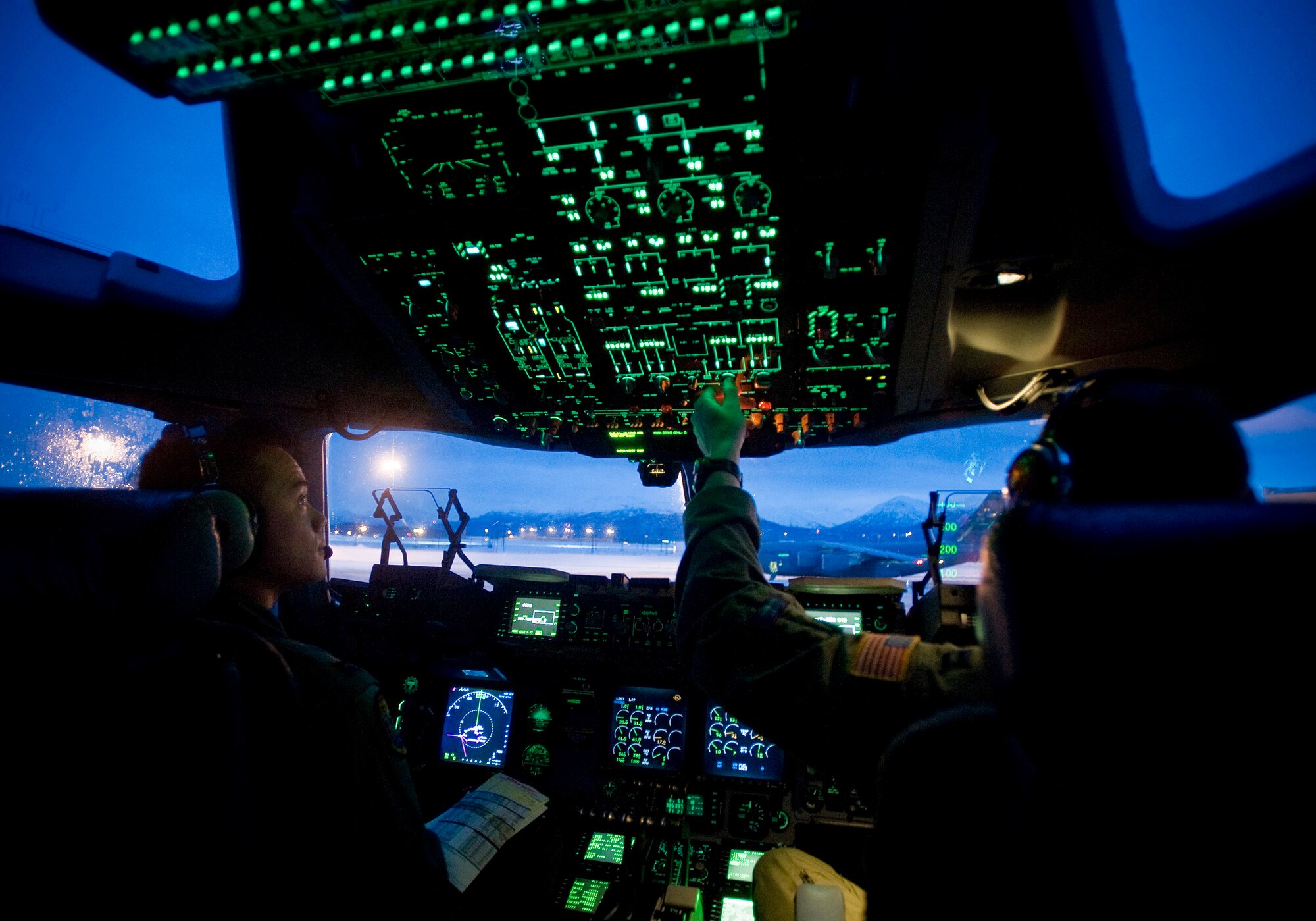 ELMENDORF AIR FORCE BASE, Alaska -- Capt. John Ma and Capt. Matt Crockett, 535th Airlift Squadron, performs preflight checks prior to flight Dec. 10. The 4th Brigade Combat Team, 25th Infantry Division partnered with the 517th Airlift Squadron, Hickam and McCord Air Force Base is using this week practice jumps prior to the deployment. Roughly 1,300 4-25 Soldiers will be jumping out of C-17 Globemaster IIIs during the week. (U.S. Air Force photo/Senior Airman Jonathan Steffen)