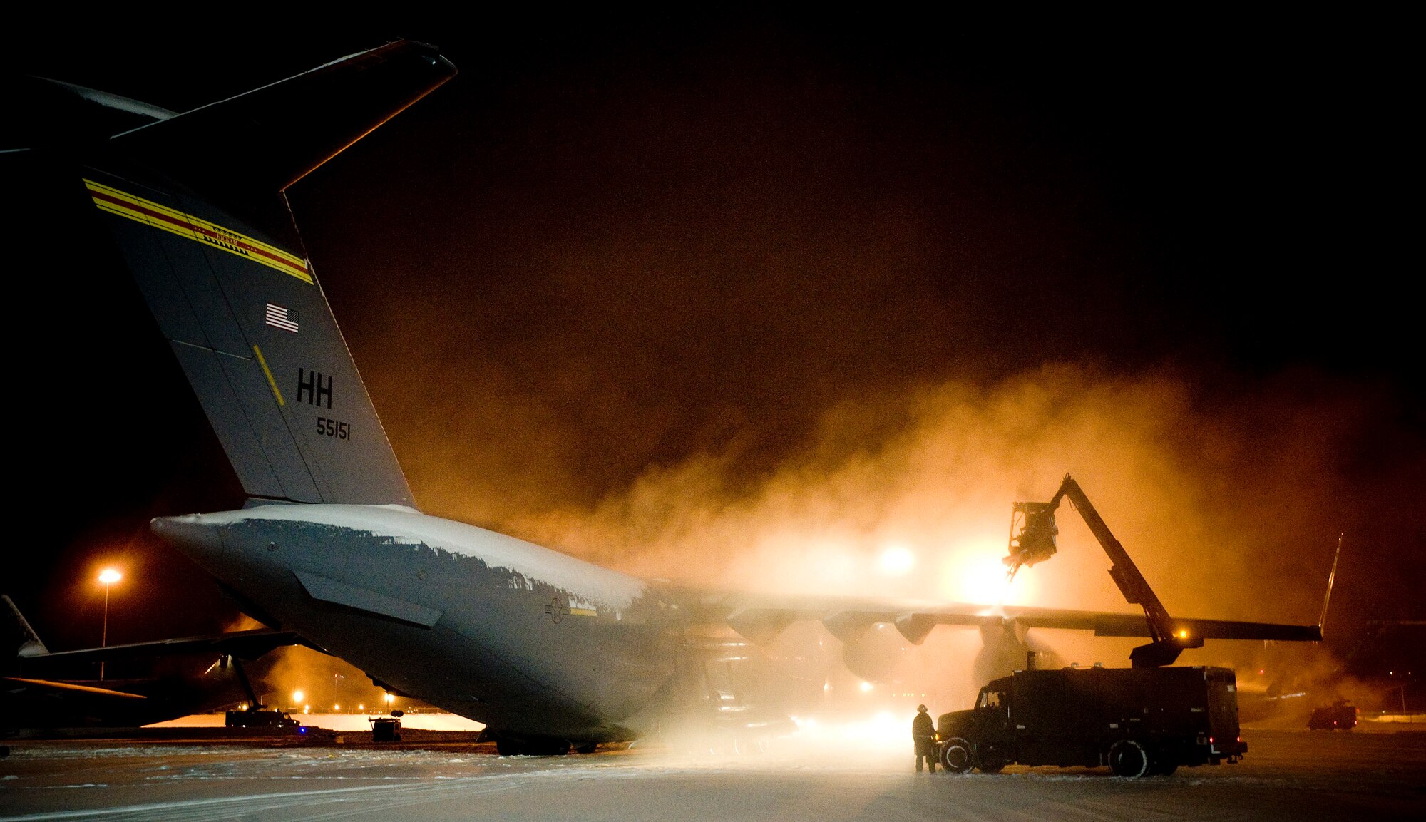 ELMENDORF AIR FORCE BASE, Alaska -- A de-icier sprays down a C-17 Globemaster III from Hickam Air Force Base prior to flight Dec. 10. The 4th Brigade Combat Team, 25th Infantry Division partnered with the 517th Airlift Squadron, Hickam and McCord Air Force Base is using this week practice jumps prior to the deployment. Roughly 1,300 4-25 Soldiers will be jumping out of C-17 Globemaster IIIs during the week. (U.S. Air Force photo/Senior Airman Jonathan Steffen)