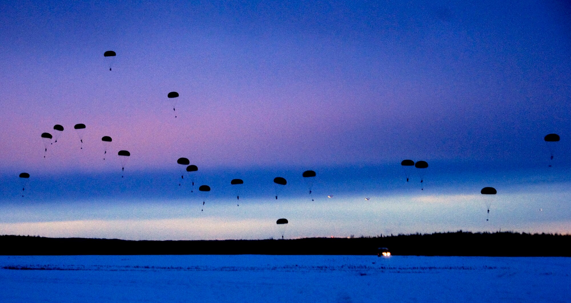 FORT RICHARDSON, Alaska -- Hundreds of 4th Brigade Combat Team, 25th Infantry Division soldiers sail to the ground Dec. 10. The 4th Brigade Combat Team, 25th Infantry Division partnered with the 517th Airlift Squadron is using this week practice jumps prior to the deployment. Roughly 1,300 4-25 Soldiers will be jumping out of C-17 Globemaster IIIs during the week. (U.S. Air Force photo/Airman 1st Class Cynthia Spalding)