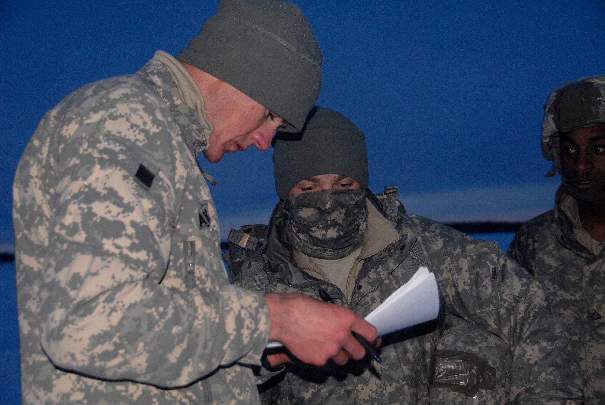 FORT RICHARDSON, Alaska -- Army Sgt. Ray Taylor, 4th Brigade Combat Team 25th Infantry Division, checks off troops names after they landed from their jump Dec. 10. The 4th Brigade Combat Team, 25th Infantry Division partnered with the 517th Airlift Squadron is using this week practice jumps prior to the deployment. Roughly 1,300 4-25 Soldiers will be jumping out of C-17 Globemaster IIIs during the week. (U.S. Air Force photo/Airman 1st Class Cynthia Spalding)