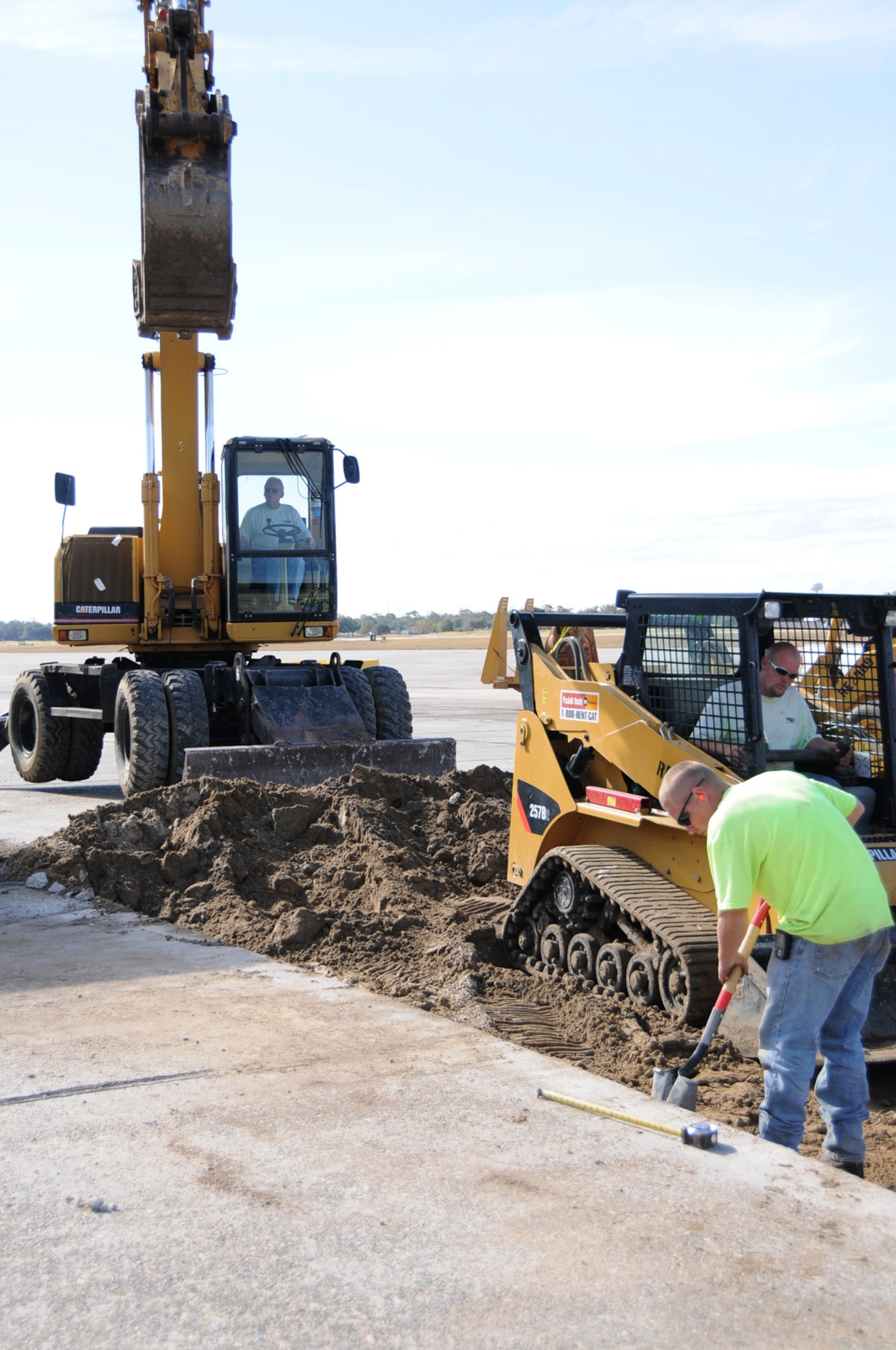 From left, contractors Quilliard Baker, Justin Schmitts and Rod Vandulman work on airfield repairs Dec. 3.  (U.S. Air Force photo by Kemberly Groue)