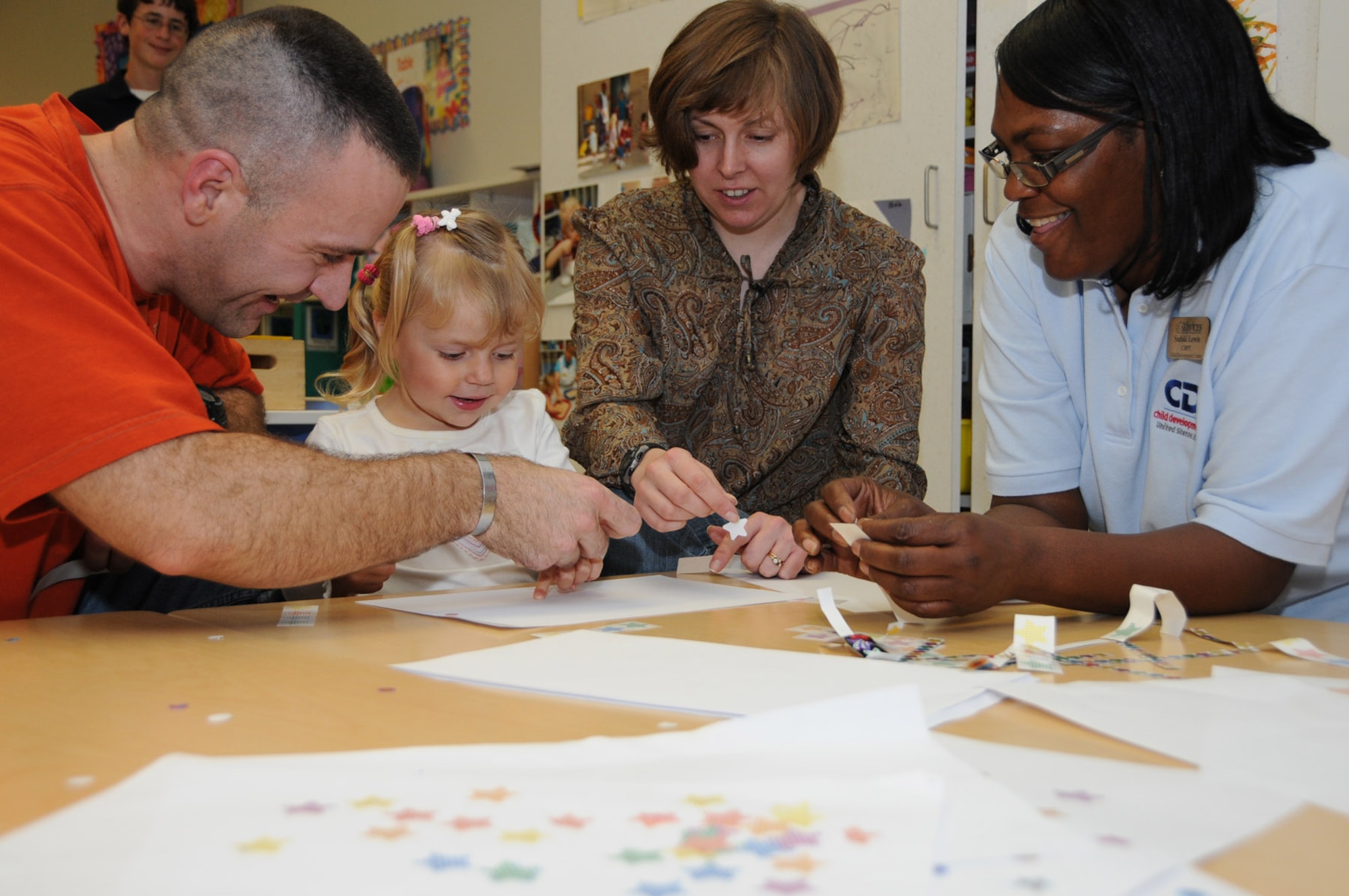 Kiera and her parents spend some time in the classroom Dec. 4 with Ms. Lewis, her teacher.  (U.S. Air Force photo by Kemberly Groue)
