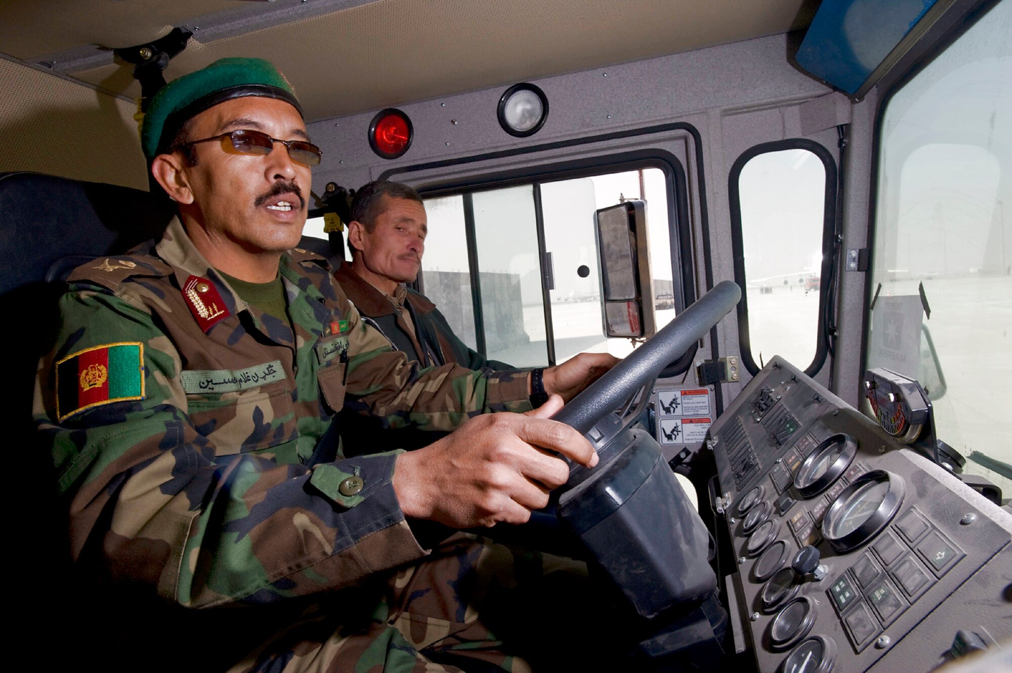 An Afghan National Army Air Corps firefighter drives a fire truck through an obstacle course during a driver training class at the Kabul International Airport, Afghanistan. The ANAAC received seven of the fire trucks, which will be distributed to several bases around Afghanistan. (U.S. Air Force photo/Master Sgt. Keith Brown)