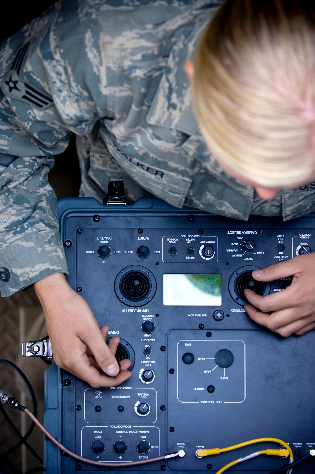 Senior Airman Emily Walker pilots a Talon explosive ordnance disposal robot from inside a mine-resistant, ambush-protected vehicle Oct. 26 at Kandahar Airfield, Afghanistan. Integrated cameras allow Airman Walker to see objects around the robot, helping her to safely handle most incidents without ever having to leave the MRAP. Airman Walker is assigned to the 755th Air Expeditionary Group Explosive Ordnance Disposal Operation Location-Bravo and deployed from Ramstein Air Base, Germany. She hails from Brownsville, Calif. (U.S. Air Force photo/Staff Sgt. Samuel Morse) 
