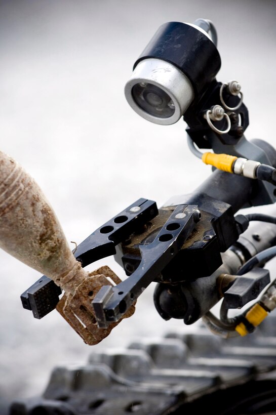 A Talon explosive ordnance disposal robot picks up a simulated piece of unexploded ordnance Oct. 26 at Kandahar Airfield, Afghanistan. Air Force EOD teams in Afghanistan respond to 46 percent all incidents involving explosives -- helping to keep not just Airmen safe, but also coalition forces of all branches and nationalities. (U.S. Air Force photo/Staff Sgt. Samuel Morse) 
