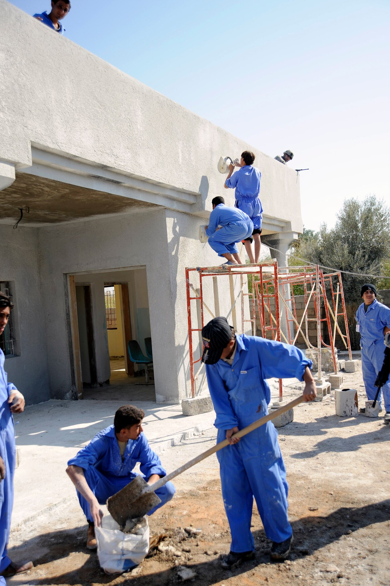 Iraqi Village of Hope workers rebuild a battle damaged home in Hawr Rajab, Iraq. The Village of Hope program taught trade skills to local citizens and helped rebuild a boy's school, community center and homes that were battle damage by al-Qaida. (U.S. Air Force photo/Staff Sgt. Paul Villanueva II) 
