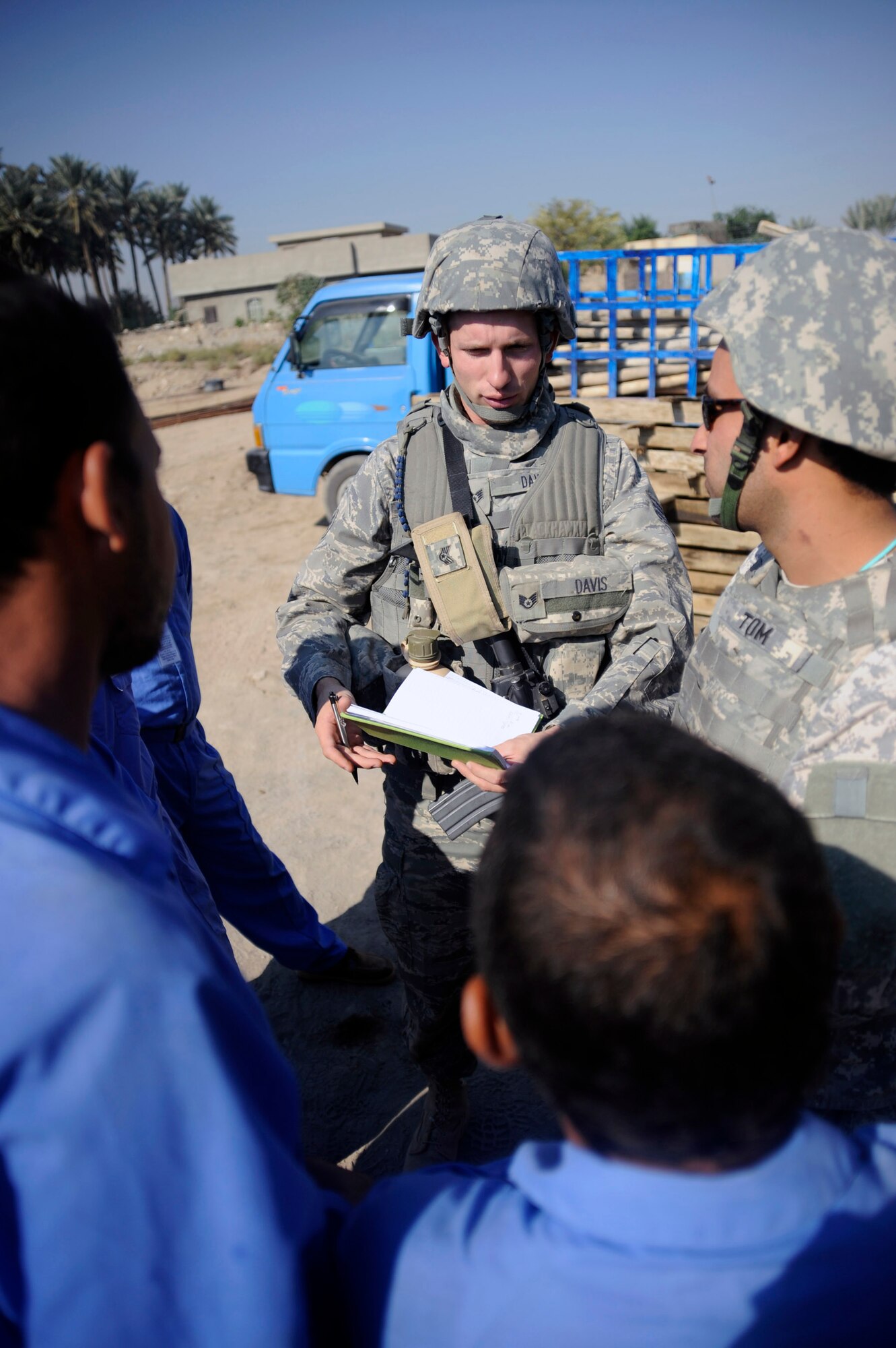 Staff Sgt. Christopher Davis talks with site supervisors about the progress being made to the house and community center under construction in Hawr Rajab, Iraq. Sergeant Davis is a contracting officer representative for the Village of Hope program. He is a Hamilton, Mo. native, and deployed from the 820th RED HORSE Squadron from Nellis Air Force Base, Nev., where he is an airborne structural craftsman. (U.S. Air Force photo/Staff Sgt. Paul Villanueva II) 
