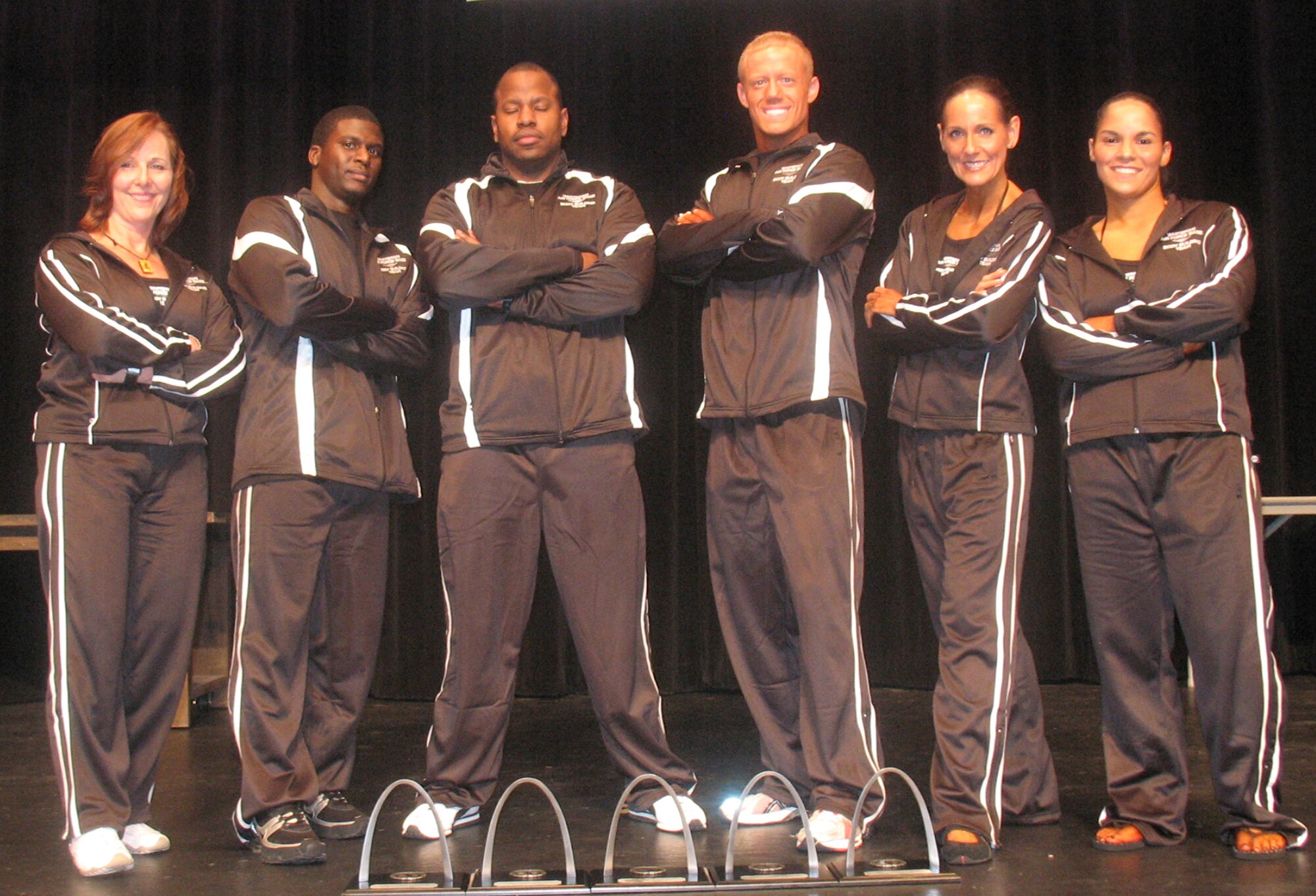 WHITEMAN AIR FORCE BASE, Mo. – (Left to Right) Dr. Nita Hawk, Staff Sgt. Ronnie Campbell, Capt. Michael Boswell, Senior Airman Stephen Linch, Murica Simmering and Staff Sgt. Sonya Campbell, Whiteman Body Building Team, pose for a photo Oct. 25. Of 15 hopefuls only five made it to competition day. Collectively, the team lost more than 120 pounds and spent more than 40,000 hours in preparation in the months leading up to the competitions where they won six trophies. Master Sgt. Dana Fraher is not pictured. (Photo printed with permission of Capt. Boswell)