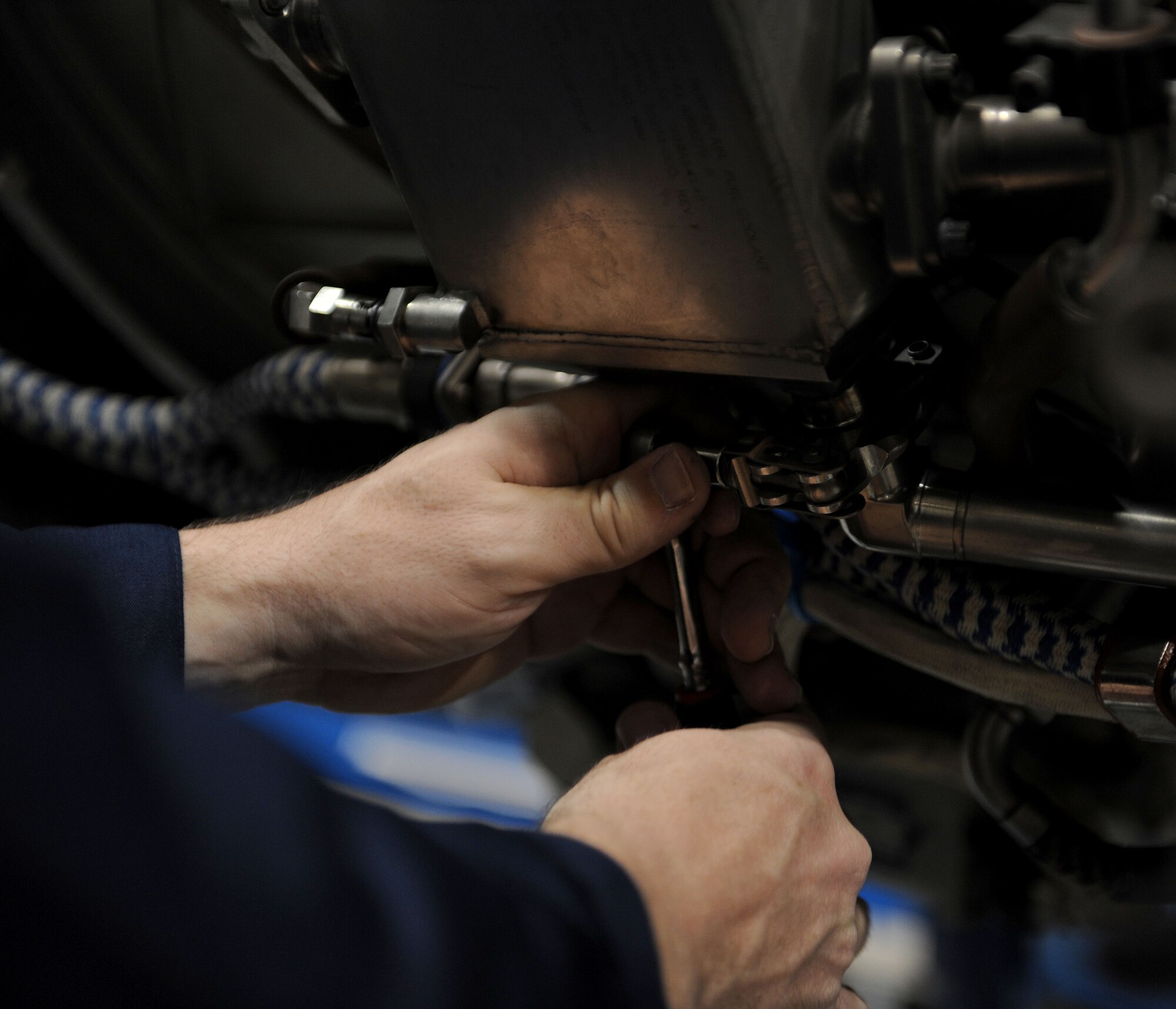 LANGLEY AIR FORCE BASE, Va. --  Chief Master Sgt. Kevin Slater, 1st Fighter Wing command chief, loosens a bolt on the engine of an F-22 at the 1st Component Maintenance Squadron Dec. 10. Chief Slater toured the squadron and received a lesson on the engines while getting to know some of the Airmen.  (U.S. Air Force photo/Airman Rebecca Montez)