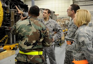 LANGLEY AIR FORCE BASE, Va. -- Master Sgt. Rodger L. Solomon Jr., and Tech. Sgt. Michael Veale Jr., from the 1st Component Maintenance Squadron, point out parts of an F-22 engine to Chief Master Sgt. Kevin Slater, 1st Fighter Wing command chief, and Staff Sgt. Tracy Anderson, command chief assistant,  Dec. 10. Chief Slater toured the squadron and received a lesson on the engines while getting to know some of the Airmen.  (U.S. Air Force photo/Airman Rebecca Montez)