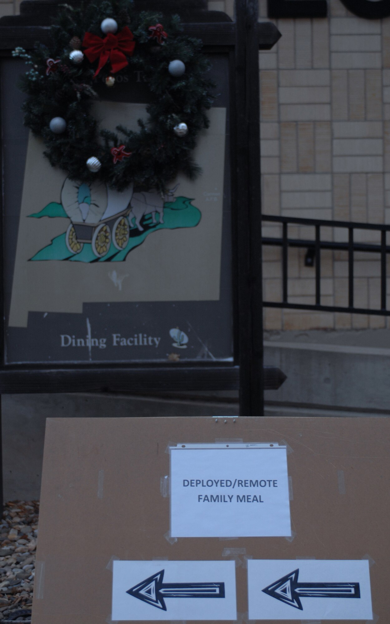CANNON AIR FORCE BASE, N.M. -- A sign points into the Pecos Trail Dining Facility to show family members of deployed/remote personnel where to go for the quarterly dinner held by the Airman and Family Readiness Center Dec. 9. Any questions about monthly or quarterly events can be answered by Tech. Sgt. Tory Gard, 27th Special Operations Mission Support Squadron, at 784-4456. (U.S. Air Force photo by Airman 1st Class James R. Bell)