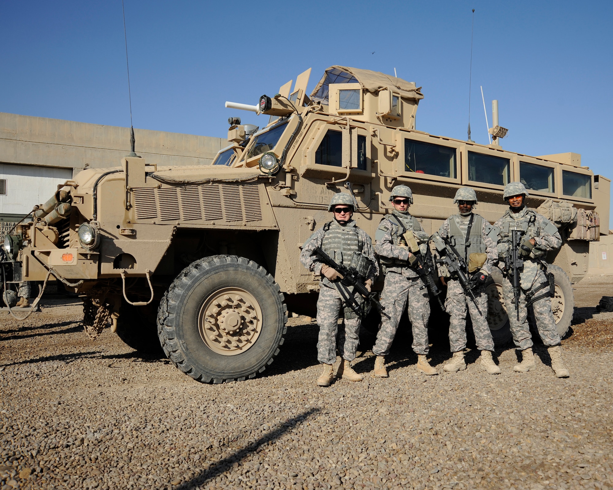 HAWR RAJAB, Iraq -- Col. Wilfred Cassidy, left, Staff Sgt. Christopher Davis, Master Sgt. Kyle Wiggins and Chief Master Sgt. Mark Darden, all of the 557th Expeditionary RED HORSE Squadron, pose for a photograph at Camp Stryker, Iraq on Dec. 5. (U.S. Air Force photo/Staff Sgt. Paul Villanueva II)
