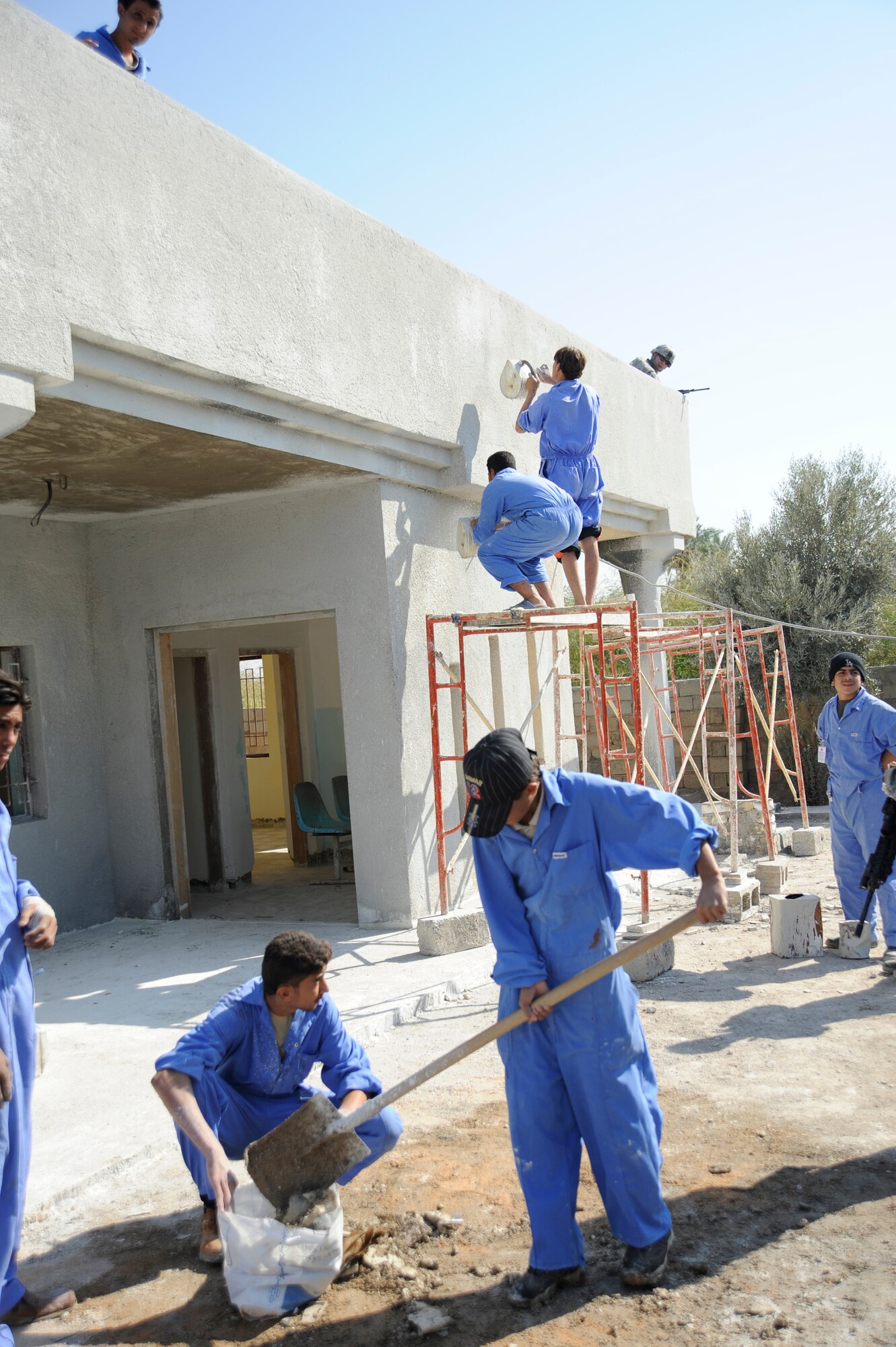 HAWR RAJAB, Iraq -- Iraqi Village of Hope workers rebuild a battle damaged home in Hawr Rajab, Iraq. Village of Hope program taught trade skills to local citizens and helped rebuild a boy's school, community center and homes that were battle damage by al-Qaida. (U.S. Air Force photo/Staff Sgt. Paul Villanueva II)