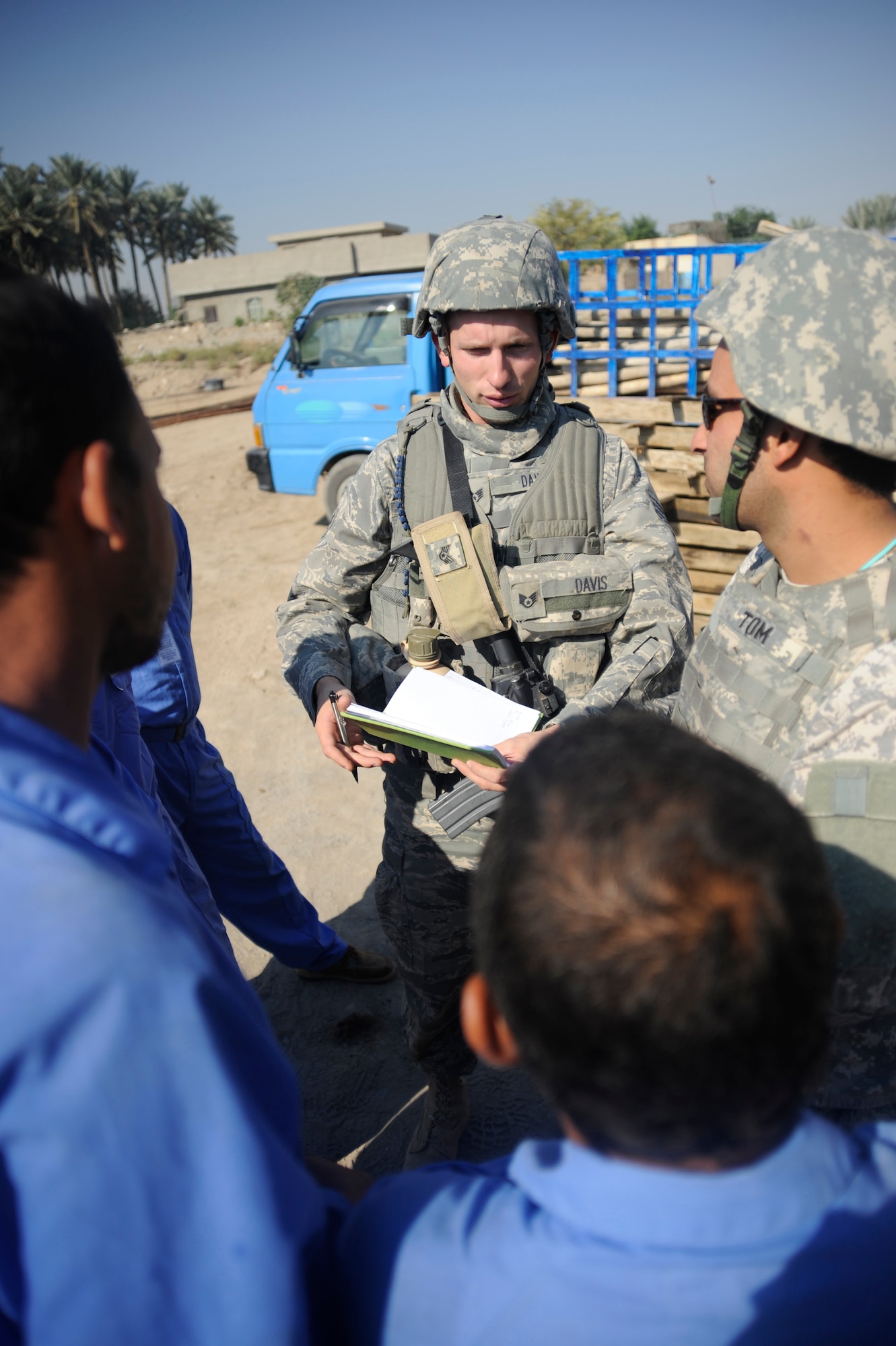 HAWR RAJAB, Iraq -- Staff Sgt. Christopher Davis, a contracting officer representative for the Village of Hope program, talks with site supervisors about the progress being made to the house and community center under construction in Hawr Rajab, Iraq. Davis, a Hamilton, Mo. native, is deployed from the 820th RED HORSE Squadron, Nellis Air Force Base, Nev., where he is an airborne structural craftsman. (U.S. Air Force photo/Staff Sgt. Paul Villanueva II)