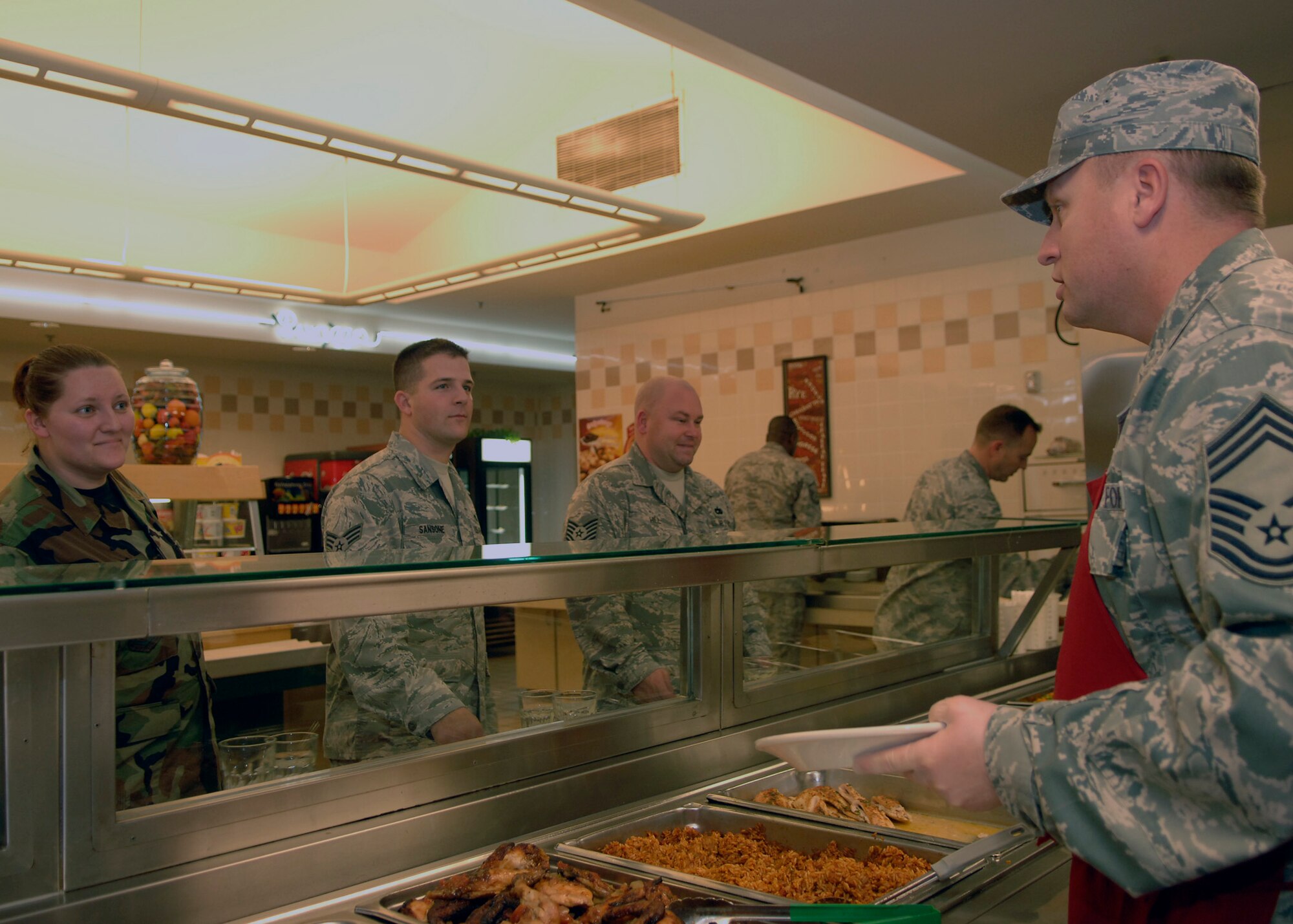 Chief Master Sgt. Rudy Tingelhoff
 serves food to Charleston AFB Airmen during lunch at the Gaylor Dining Facility 
 Dec. 10. The Charleston Chief's Group started this monthly initiative in November as another way of serving the Airmen. Chief Tingelhoff is the 437th Operations Group superintendent. (U.S. Air Force photo/Airman 1st Class Katie Gieratz)

 
