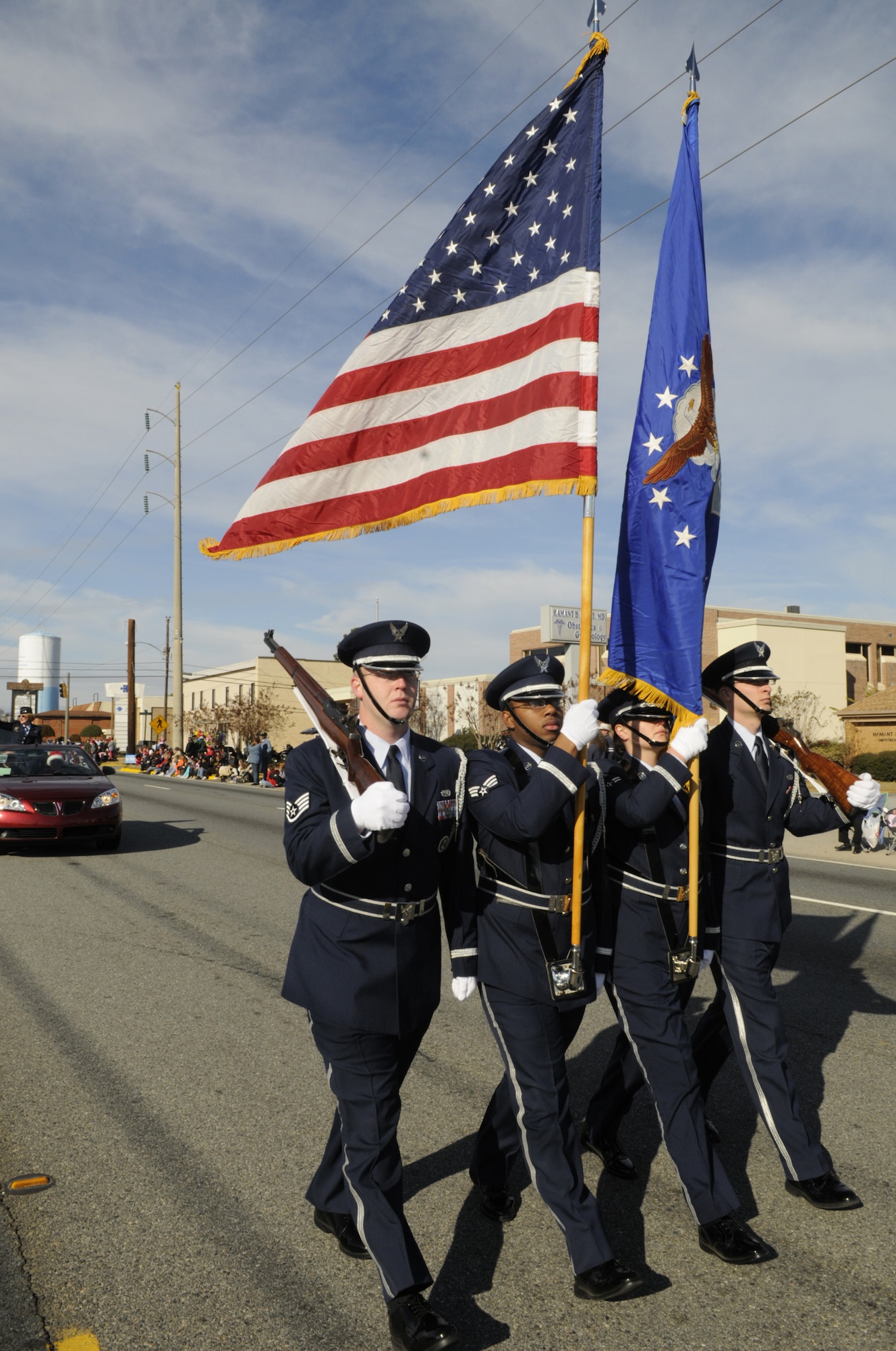 Robins Honor Guard leads the Warner Robins Christmas Parade down Watson Blvd.
They are  SSgt. MatthewTubbs, right rifle, SrA Derrick Williams, American flag, A1C Amie Amiotte, Air Force flag, and A1C Jaron Seuis, left rifle. Not pictured-  SrA Nicholas Broome, driver. U. S. Air Force photo by Sue Sapp 