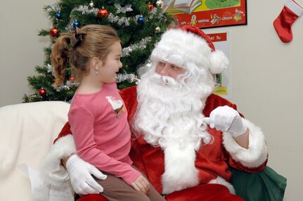 Audrey Elms tells Santa Claus what she wants for Christmas while attending the holiday classics party Dec. 9 at the base library. More than 20 children attended the party where they listened to stories, sang carols, made crafts and interacted with Santa. Audrey is the daughter of Jamie and Tech. Sgt. Jamey Elms who is assigned to the 437th Maintenance Squadron. (U.S. Air Force photo/Staff Sgt. Marie Cassetty)