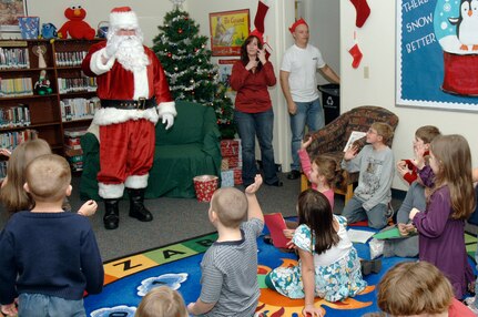Children from Charleston AFB and Naval Weapons Station, Charleston, wave to Santa Claus upon his arrival to the holiday classics party Dec. 9 at the base library. More than 20 children attended the party where they listened to stories, sang carols, made crafts and interacted with Santa. (U.S. Air Force photo/Staff Sgt. Marie Cassetty)