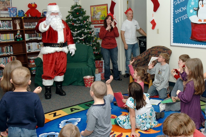 Children from Charleston AFB and Naval Weapons Station, Charleston, wave to Santa Claus upon his arrival to the holiday classics party Dec. 9 at the base library. More than 20 children attended the party where they listened to stories, sang carols, made crafts and interacted with Santa. (U.S. Air Force photo/Staff Sgt. Marie Cassetty)