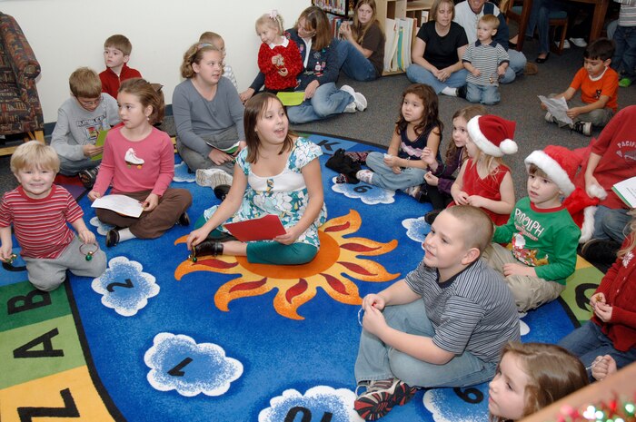 Children from Charleston AFB and Naval Weapons Station, Charleston, sing carols during the holiday classics party Dec. 9 at the base library. More than 20 children attended the party where they listened to stories, sang carols, made crafts and interacted with Santa. (U.S. Air Force photo/Staff Sgt. Marie Cassetty)