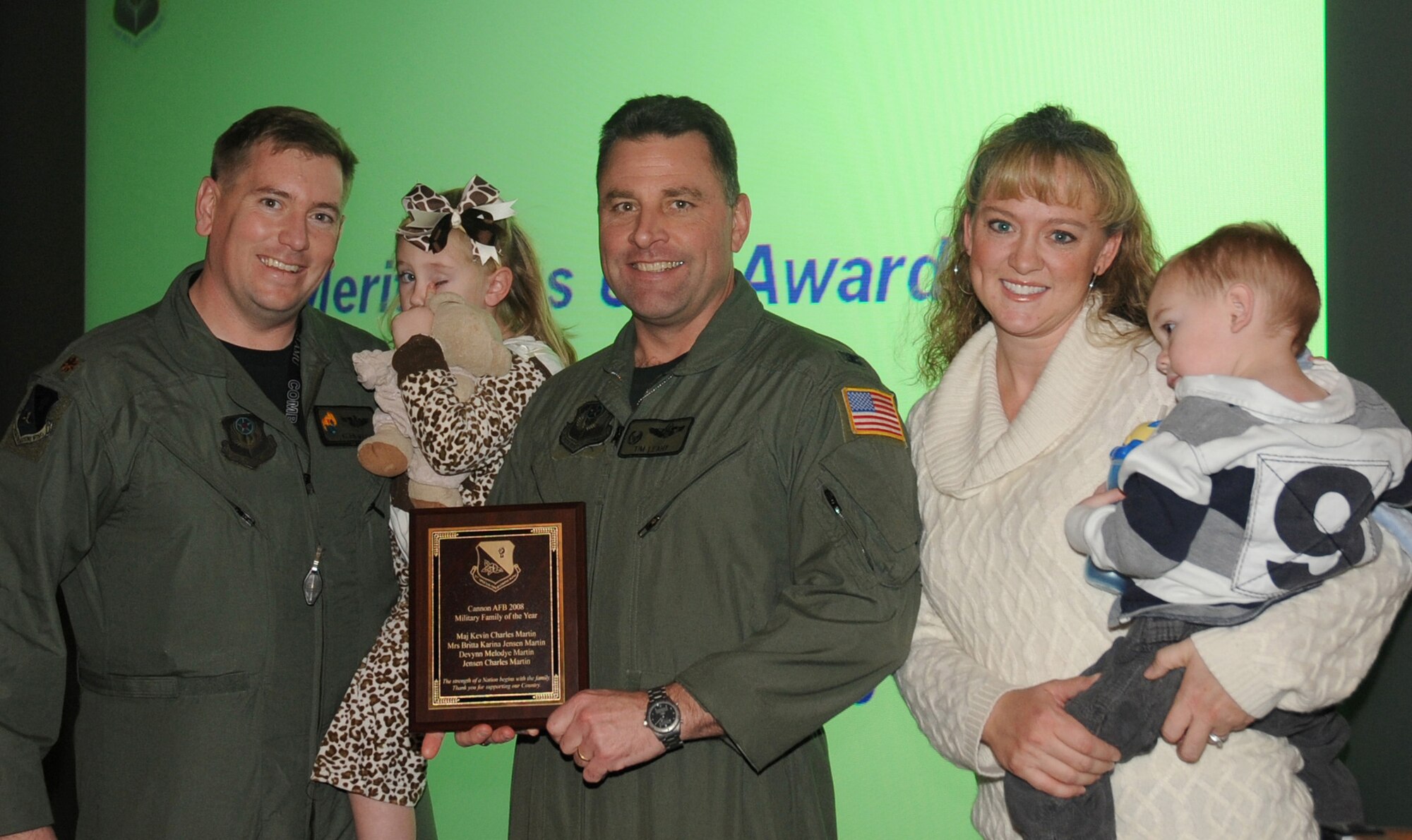 CANNON AIR FORCE BASE, N.M. -- Col. Timothy Leahy, 27th Special Operations Wing commander, presents Maj. Kevin Martin, who was  nominated by the 73rd Special Operations Squadron, and his family with the Cannon 2008 Military Family of the Year award, Dec. 9. Cannon established  the award to recognize outstanding families that support not only each other, but the community as well. (U.S. Air Force photo / Senior Airman Liliana Moreno) 